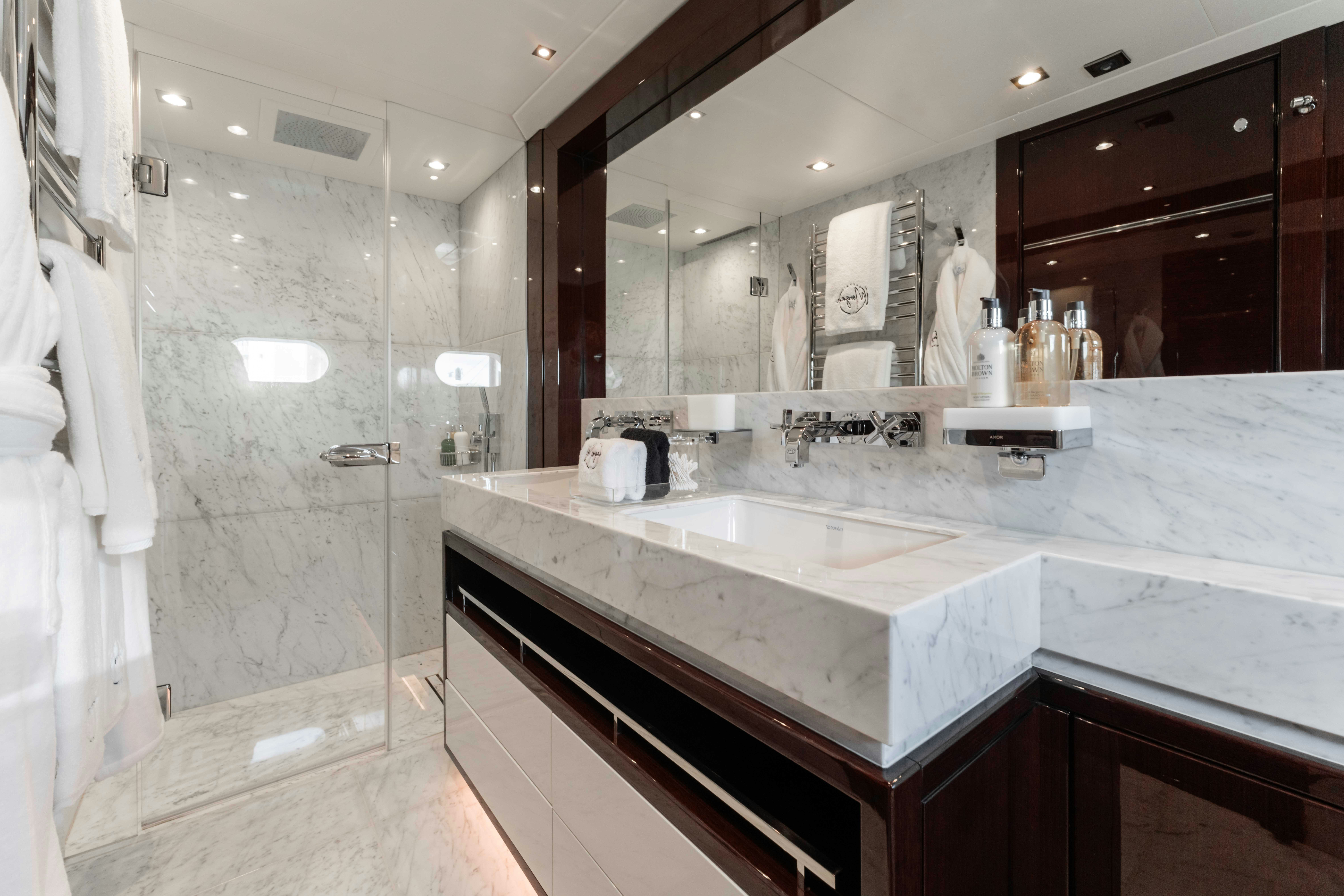 a bathroom with a large mirror aboard CAPTAIN MORGAN III Yacht for Charter
