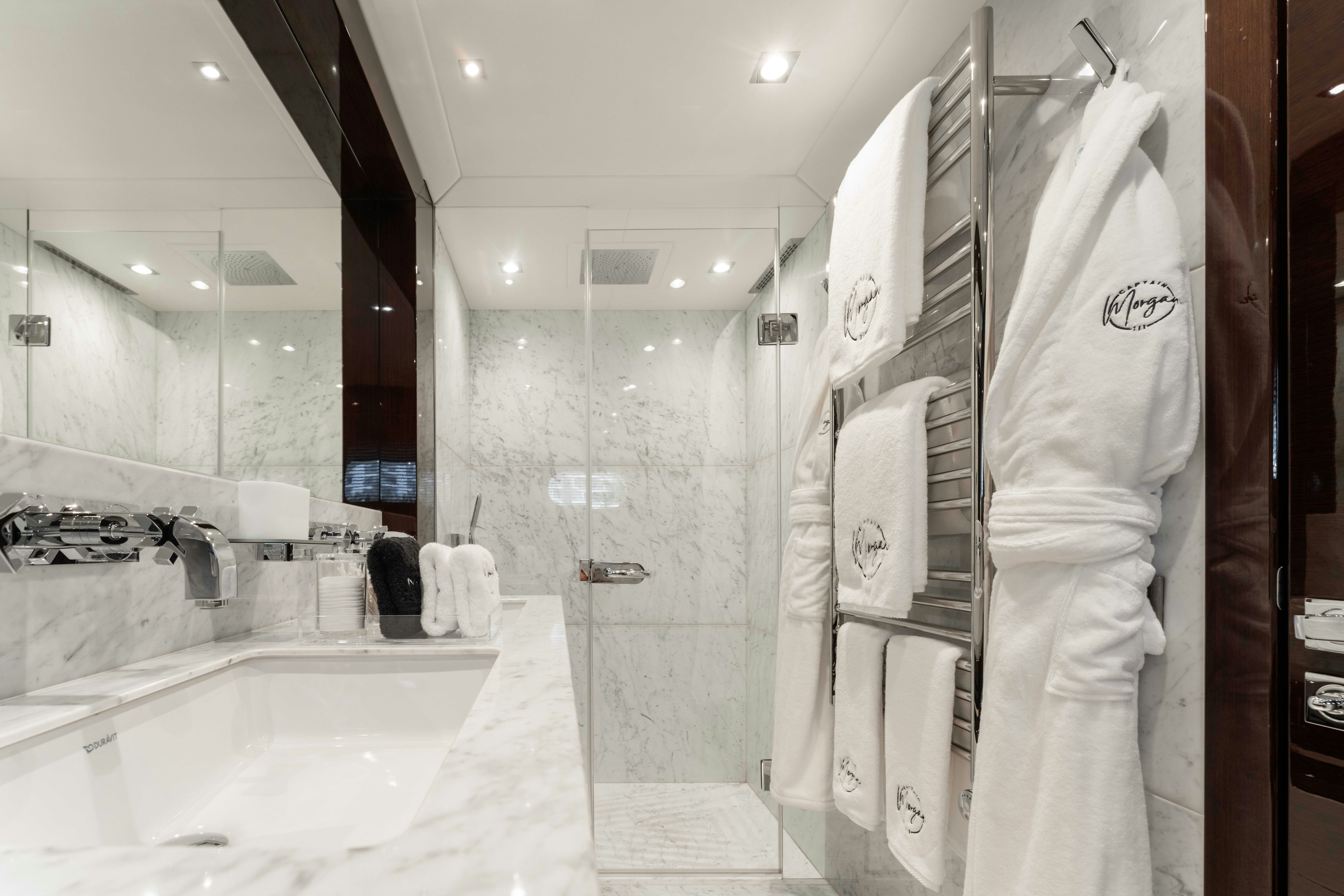 a bathroom with a robe on the wall aboard CAPTAIN MORGAN III Yacht for Charter