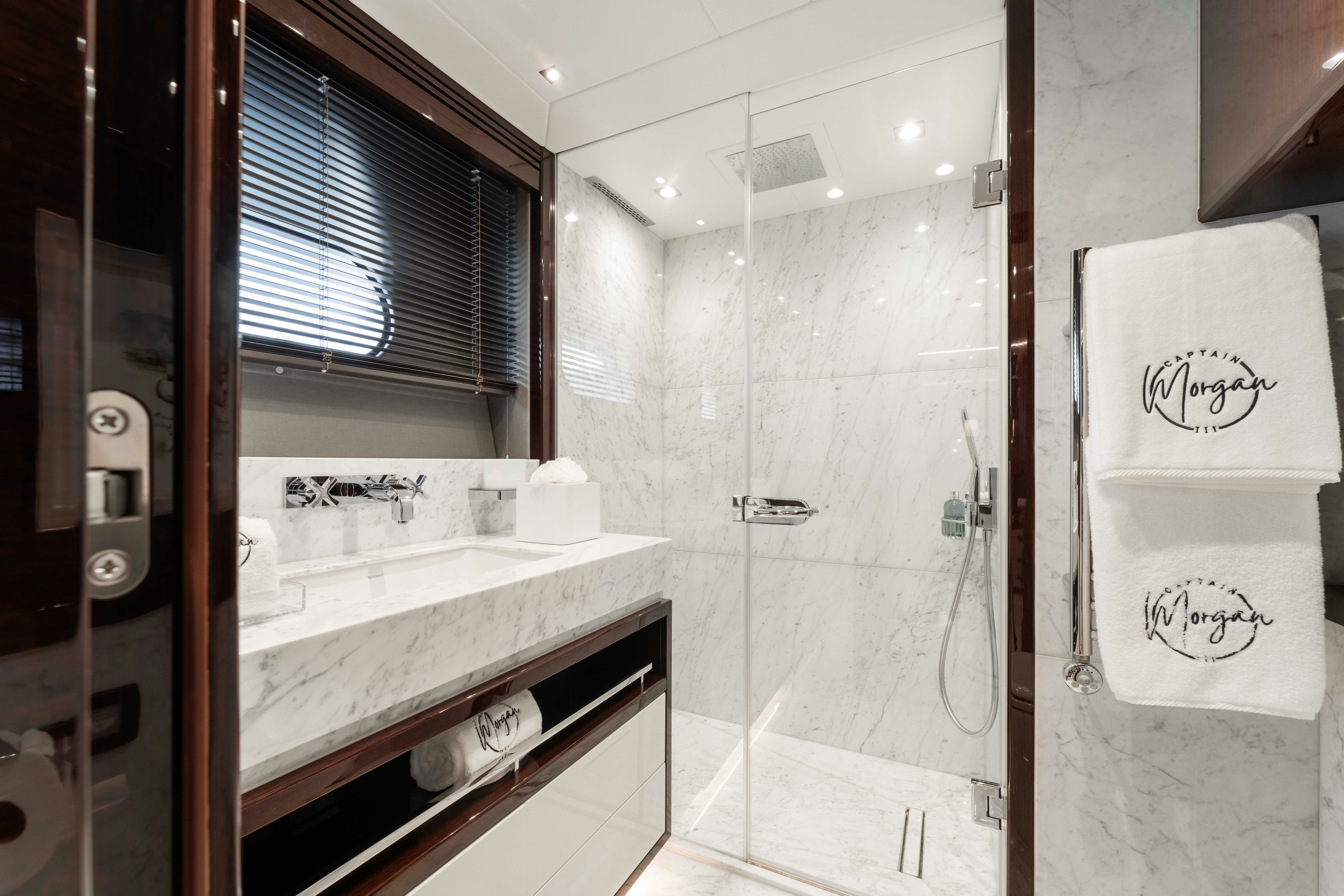 a bathroom with a sink and shower aboard CAPTAIN MORGAN III Yacht for Charter