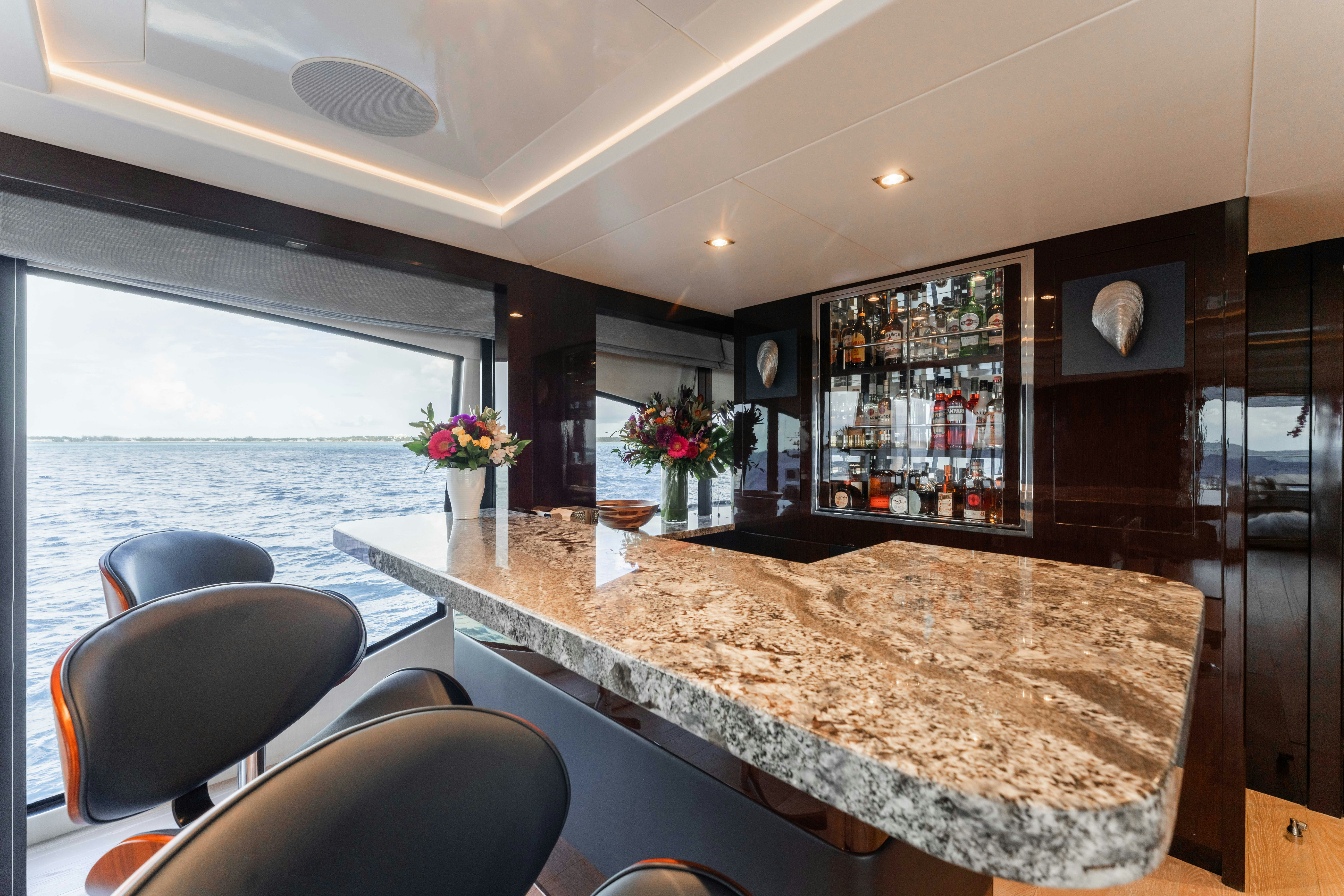 a large kitchen with a marble counter top and a large window aboard CAPTAIN MORGAN III Yacht for Charter