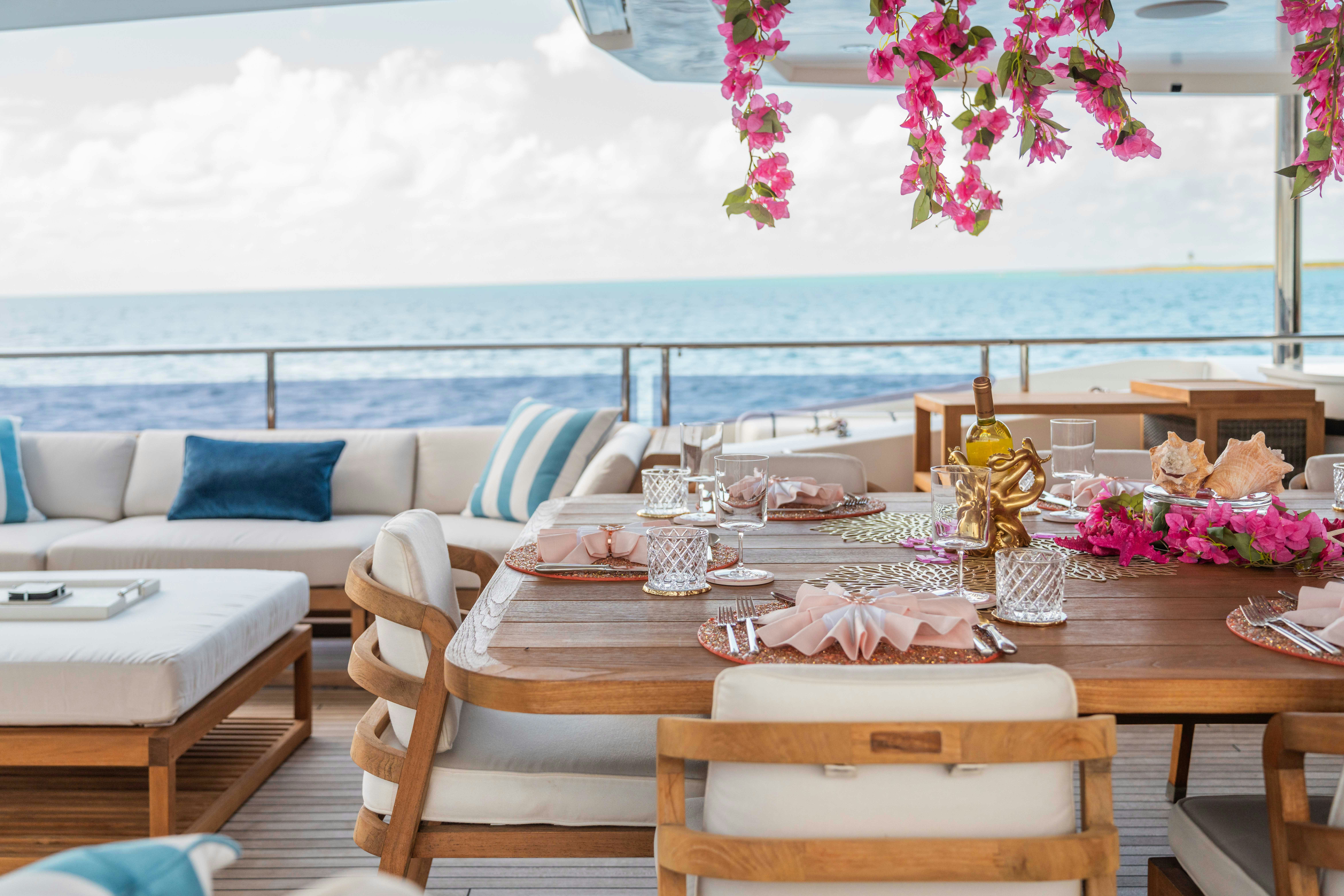 a table with chairs and a couch aboard CAPTAIN MORGAN III Yacht for Charter