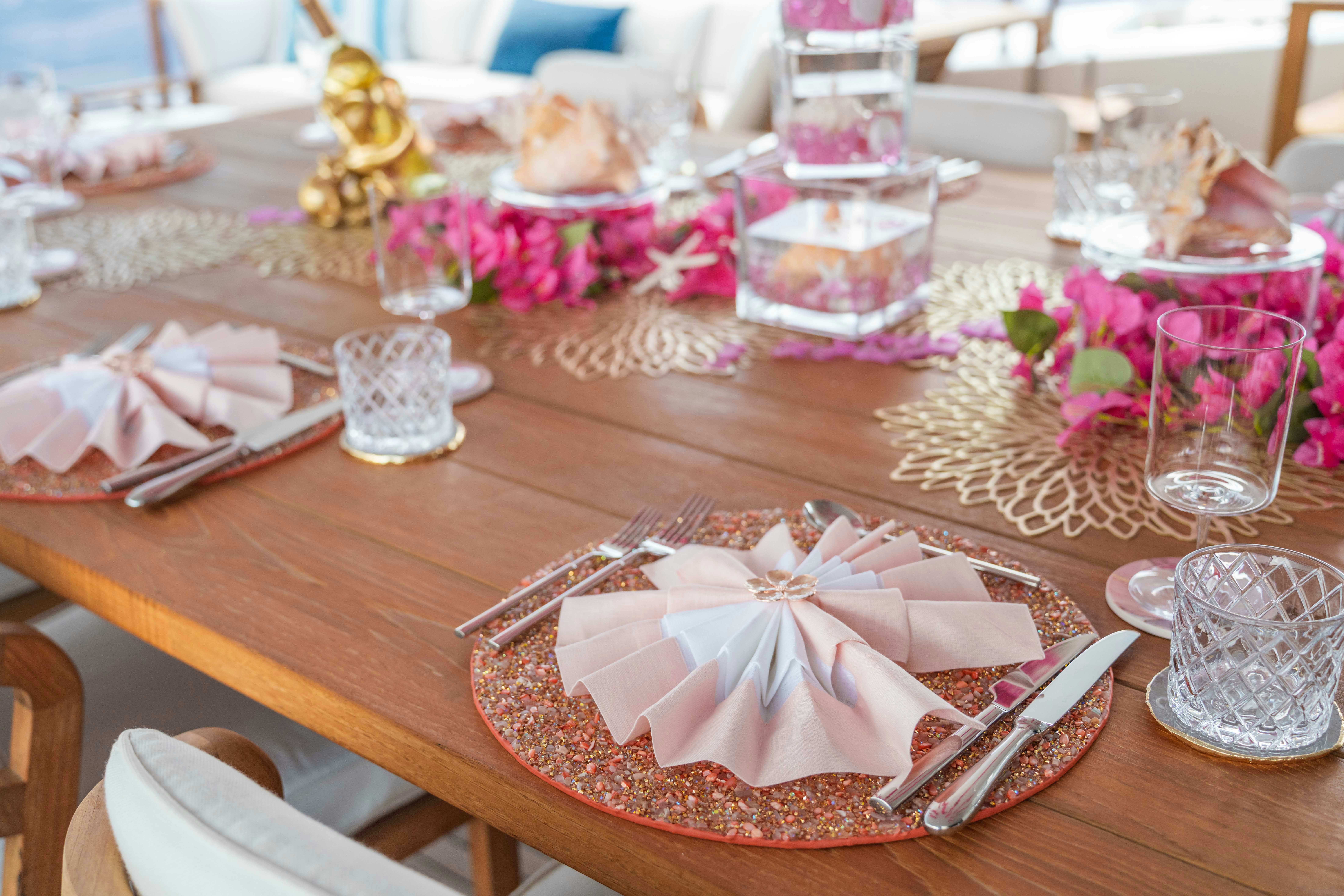 a table with a table cloth and glasses on it aboard CAPTAIN MORGAN III Yacht for Charter