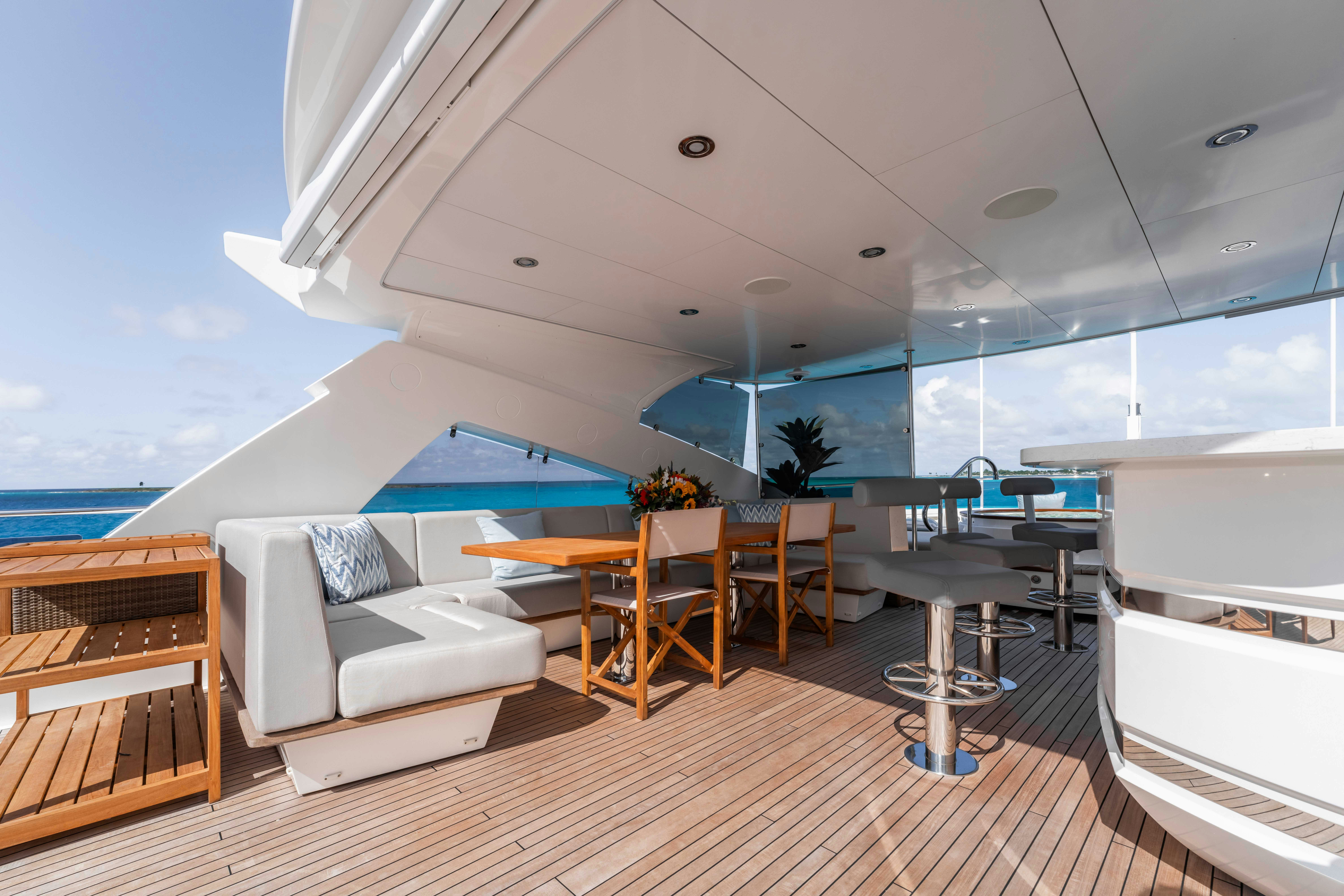 a room with a couch and a table and chairs aboard CAPTAIN MORGAN III Yacht for Charter