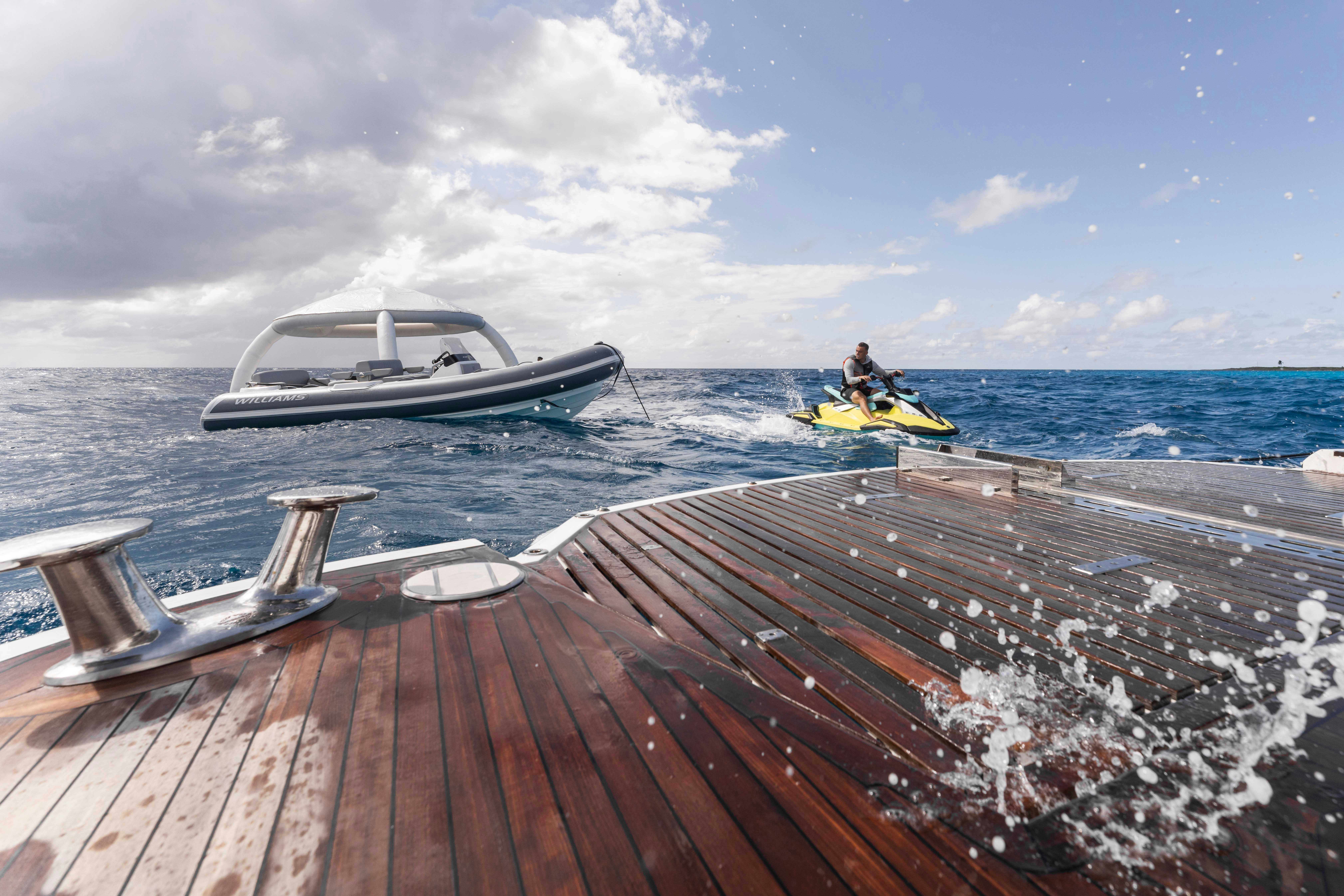 a boat and a person in a kayak on the water aboard CAPTAIN MORGAN III Yacht for Charter