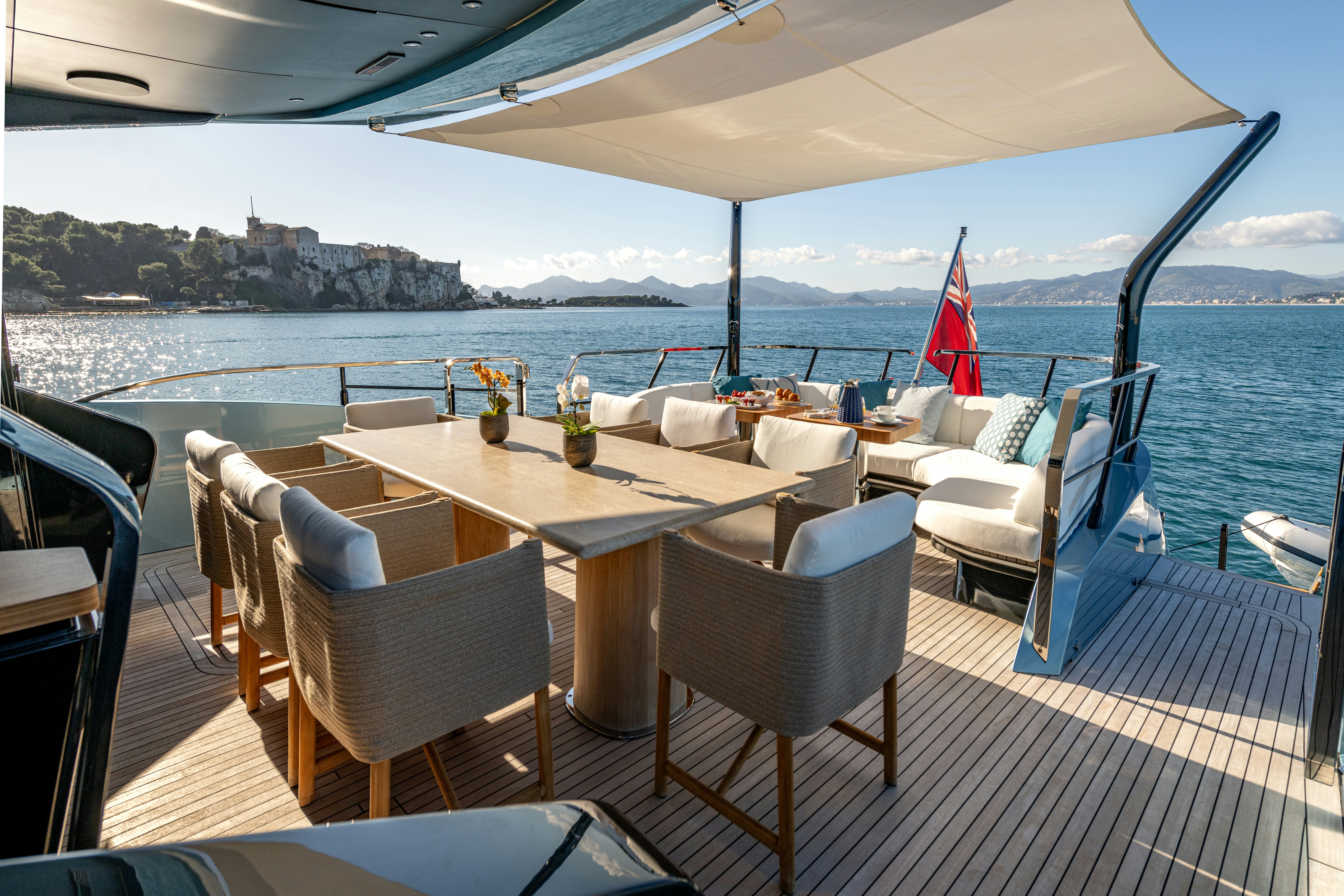 a table and chairs on a deck aboard DELFINA Yacht for Sale