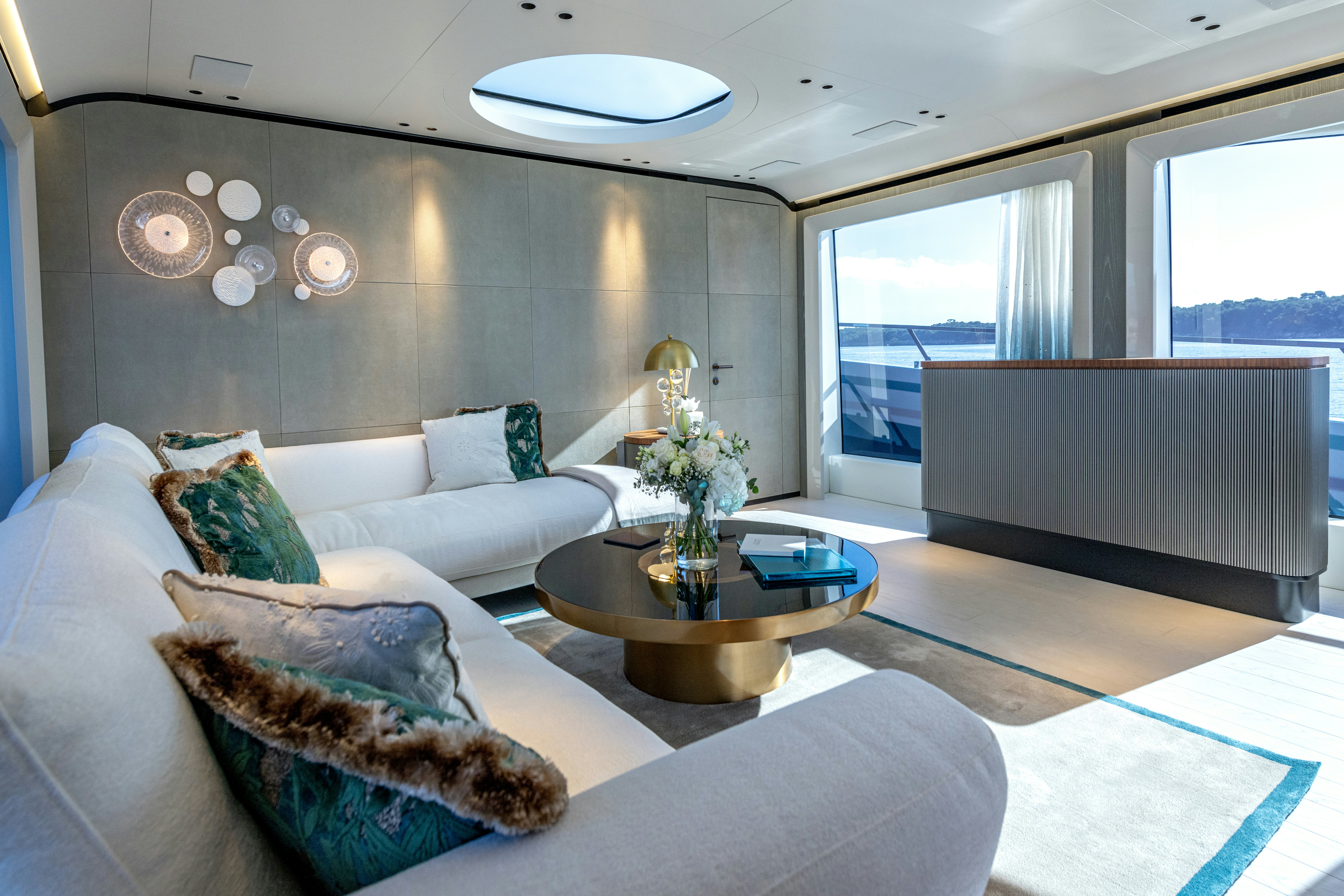 a living room with a couch and a coffee table aboard DELFINA Yacht for Sale