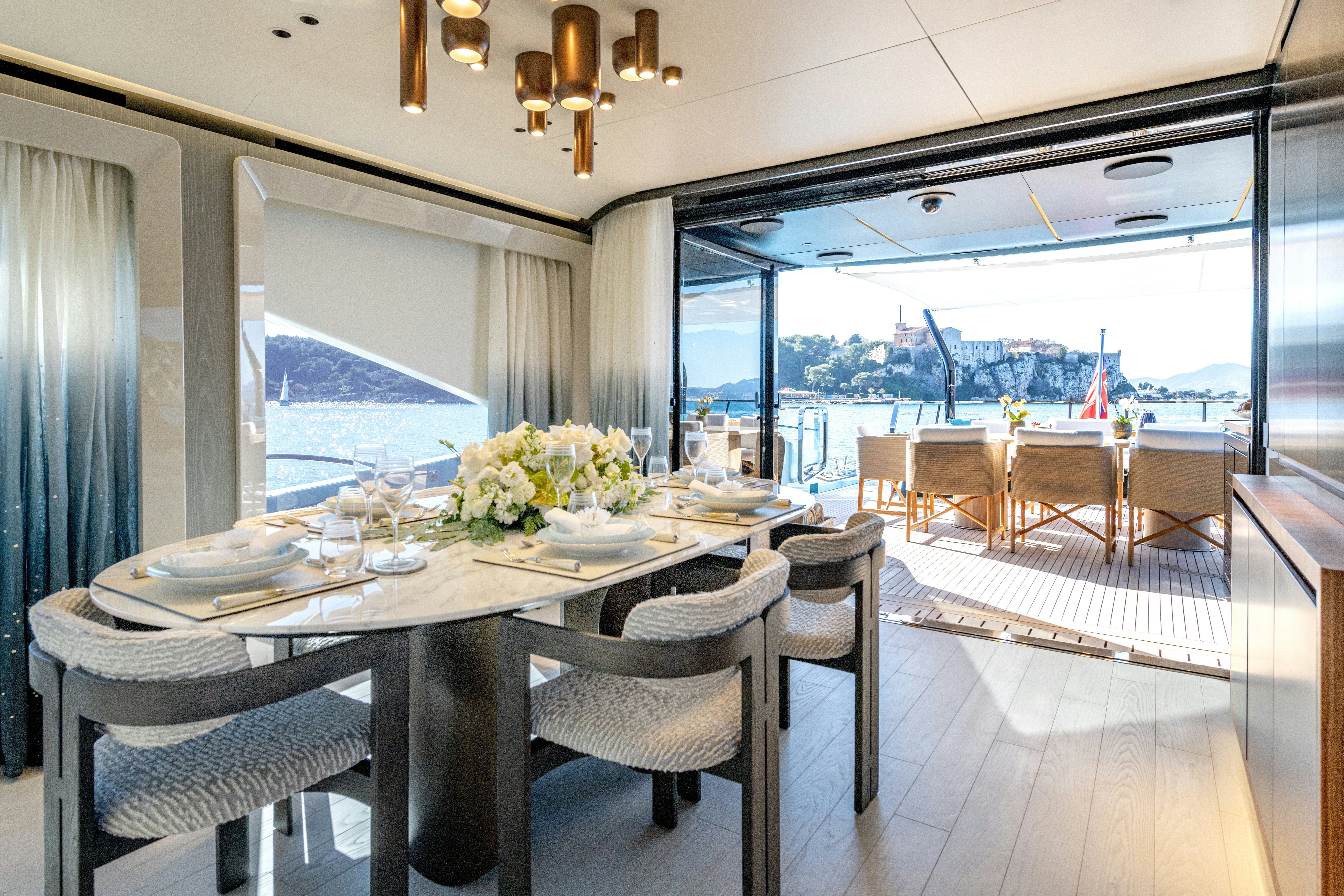 a dining table on a deck aboard DELFINA Yacht for Sale
