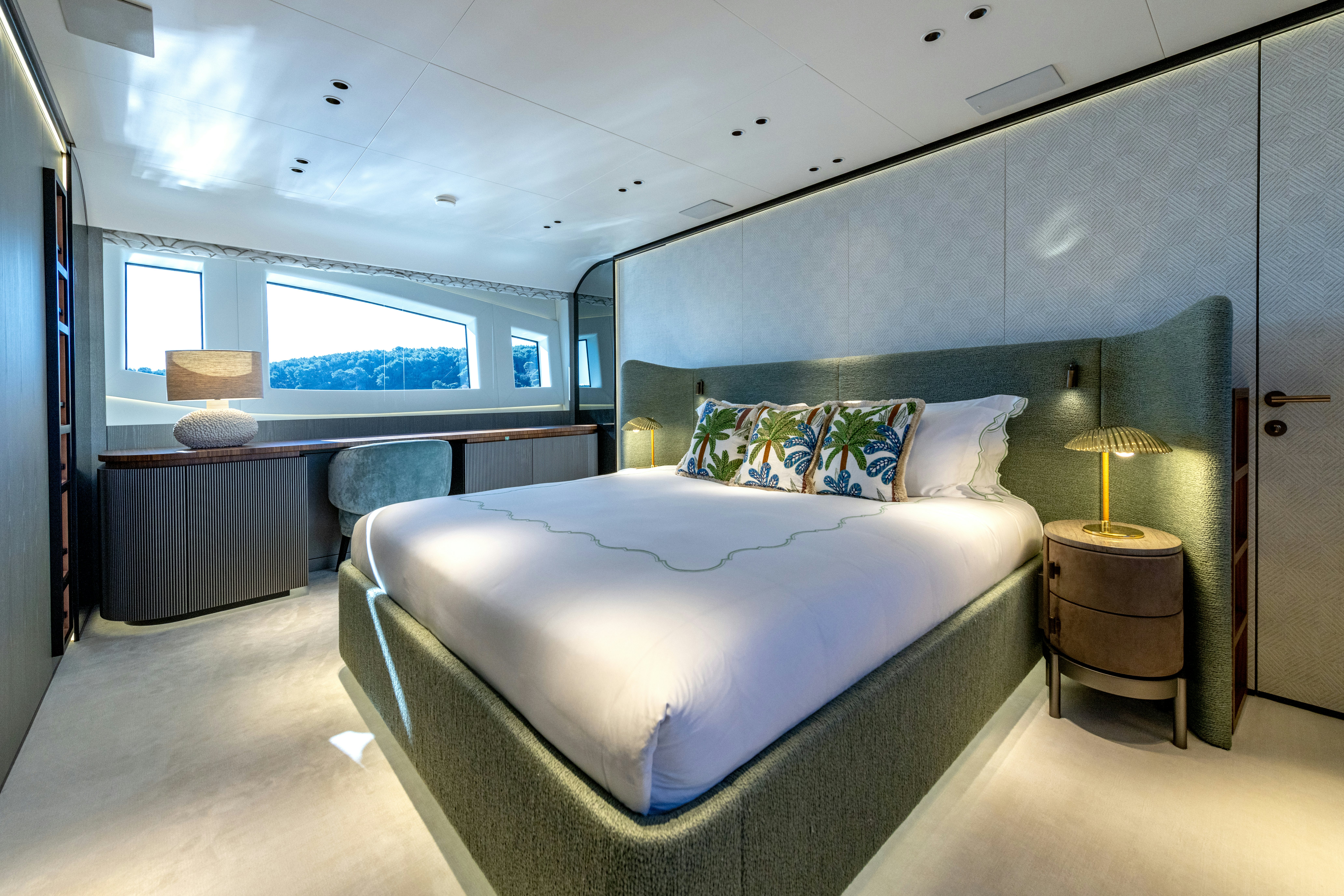 a bedroom with a bed and a desk aboard DELFINA Yacht for Sale