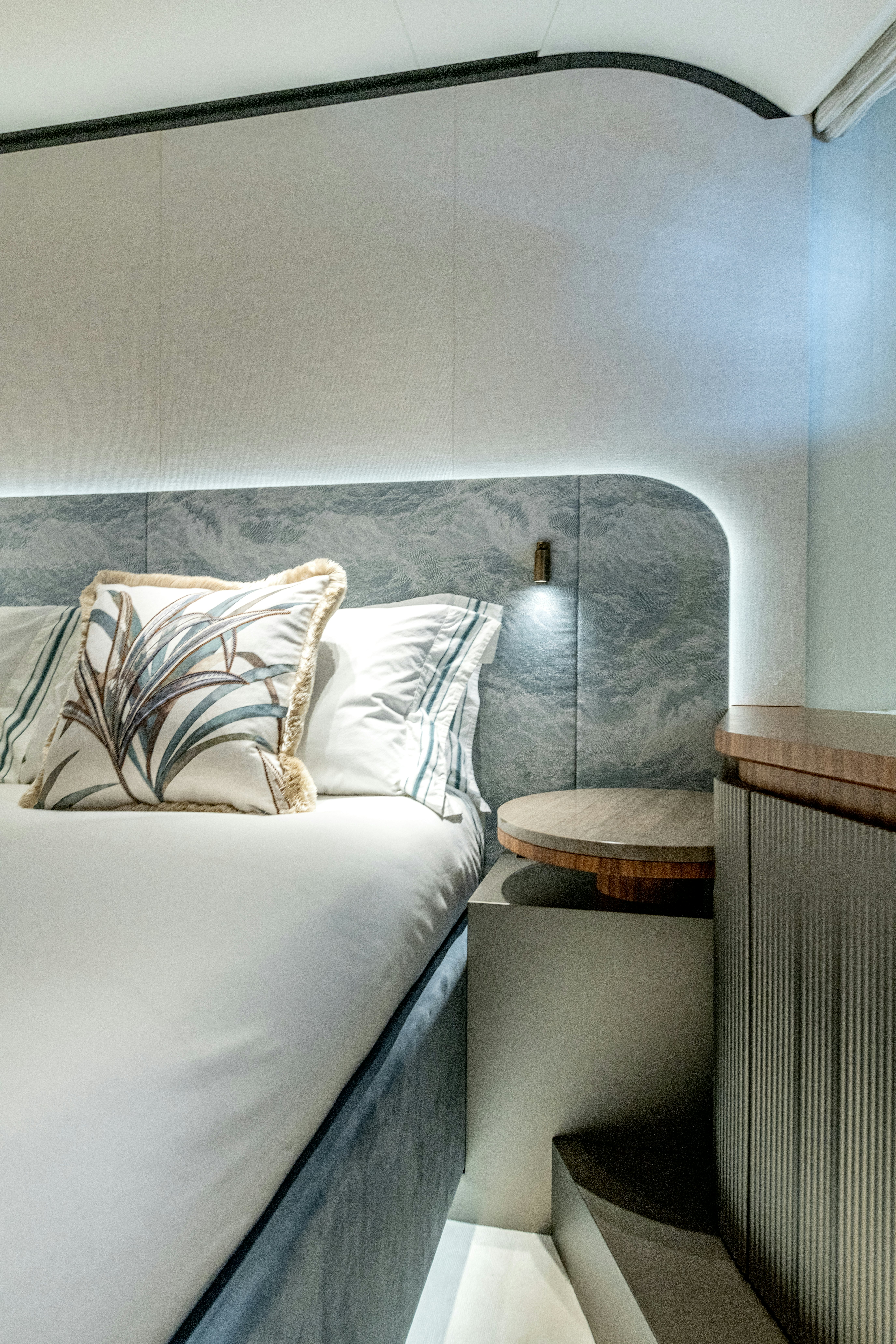a bed with a blue comforter aboard DELFINA Yacht for Sale