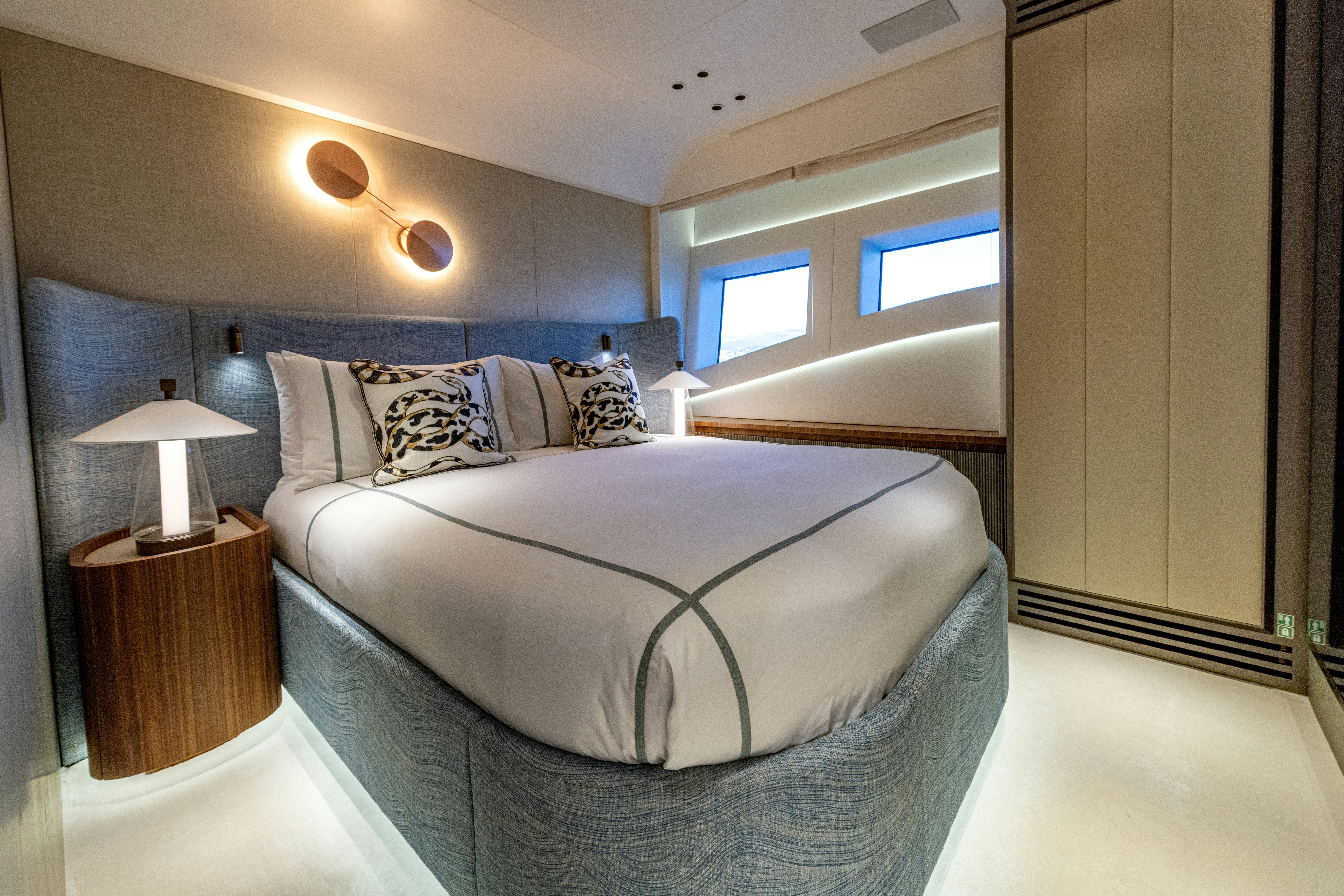a bedroom with a bed and a desk aboard DELFINA Yacht for Sale