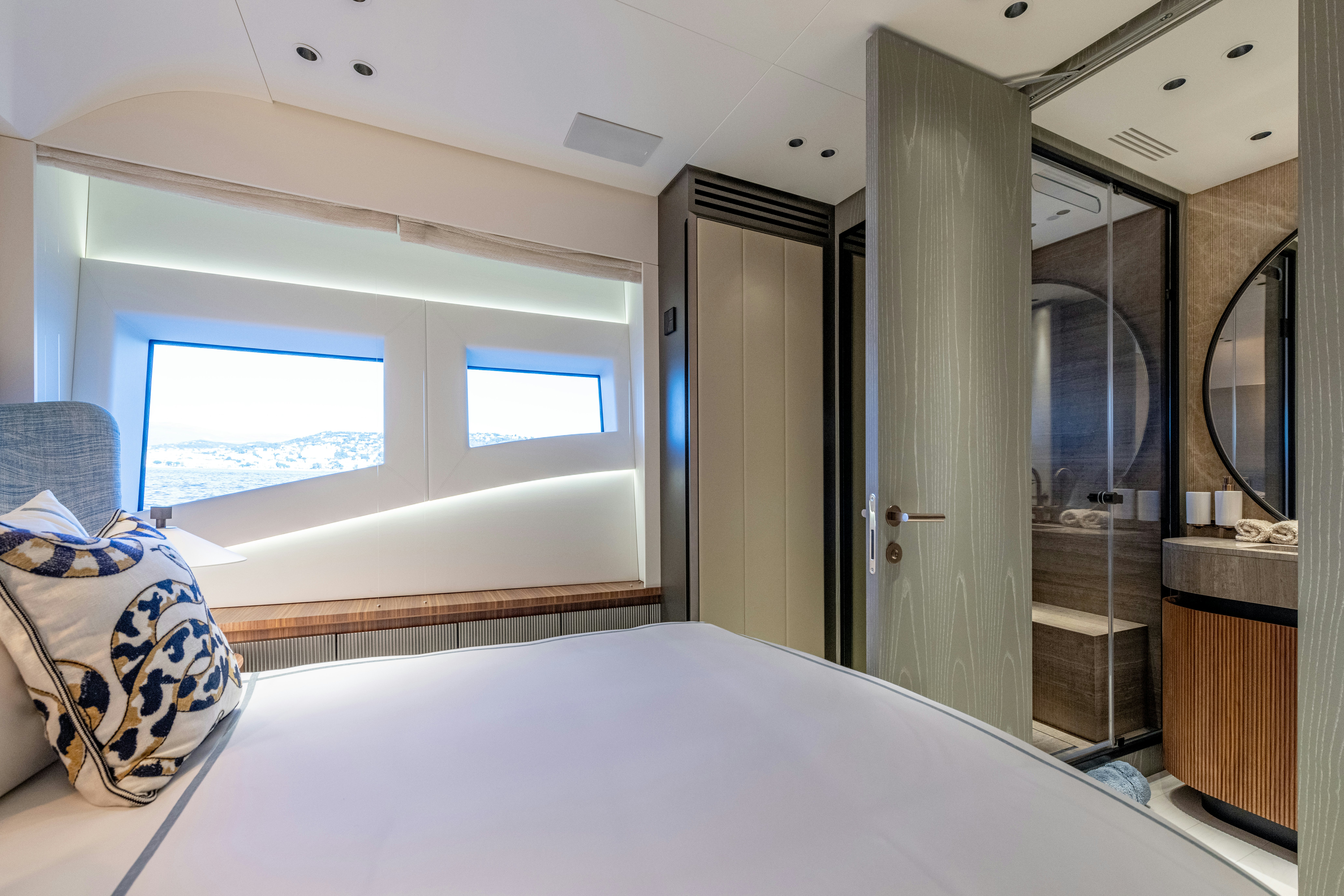 a bedroom with a bed and a mirror aboard DELFINA Yacht for Sale