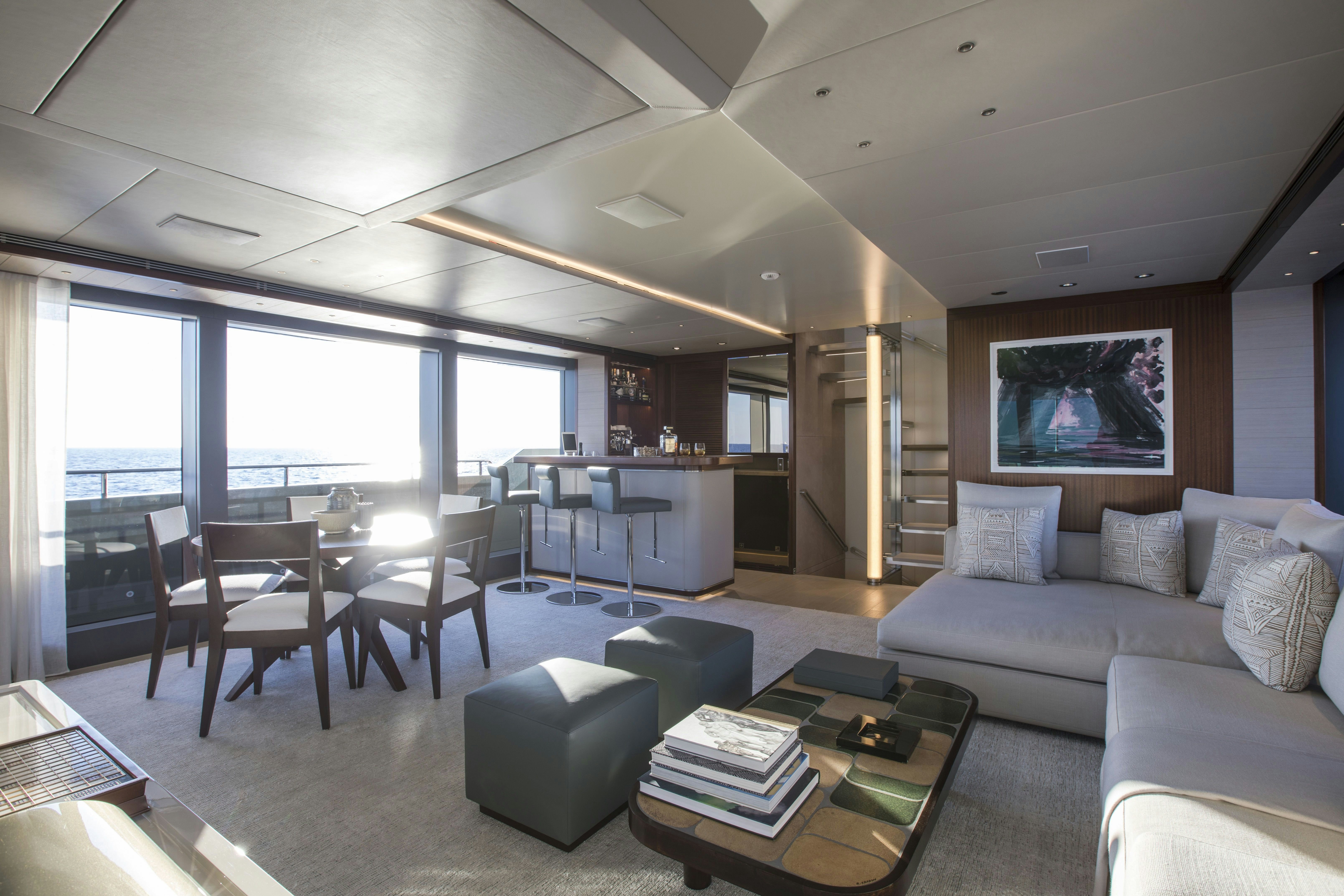 a living room with a couch and a table aboard MOKA Yacht for Charter