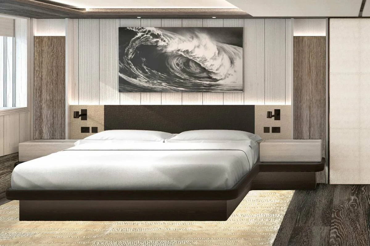 a bed with a black frame aboard LES CINQ Yacht for Charter