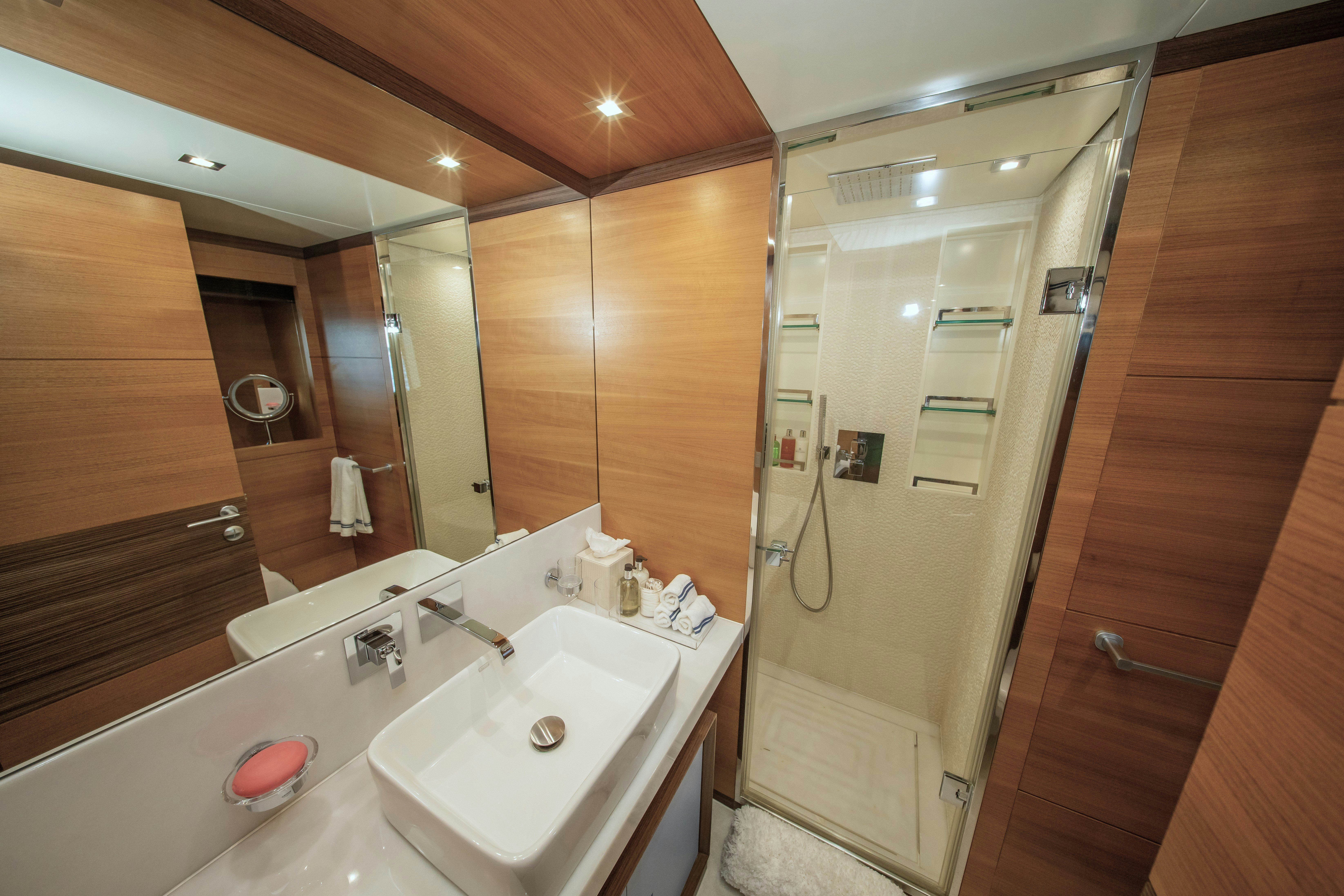 a bathroom with a large mirror aboard REHAB Yacht for Sale