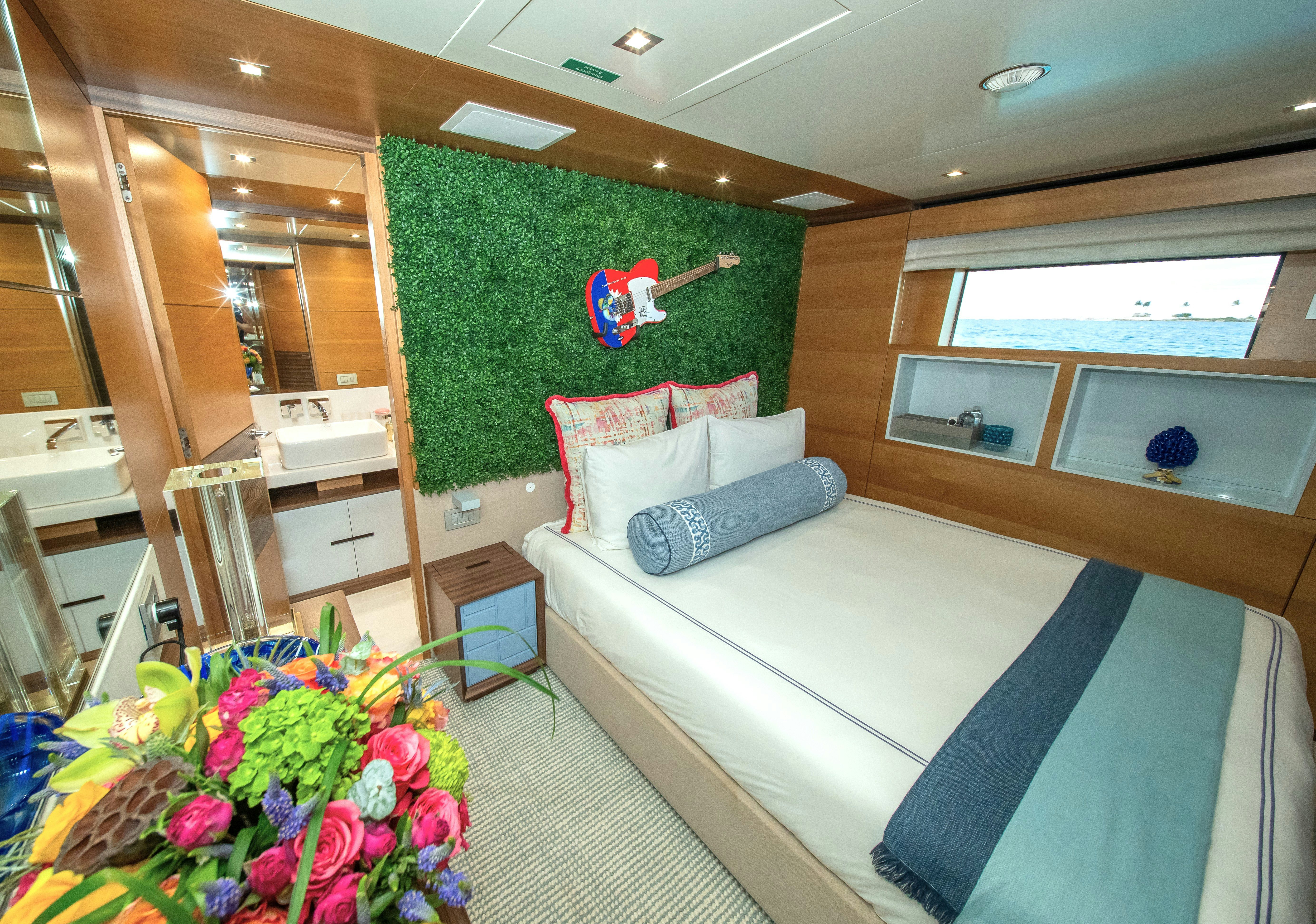 a bedroom with a bed and a green wall aboard REHAB Yacht for Sale