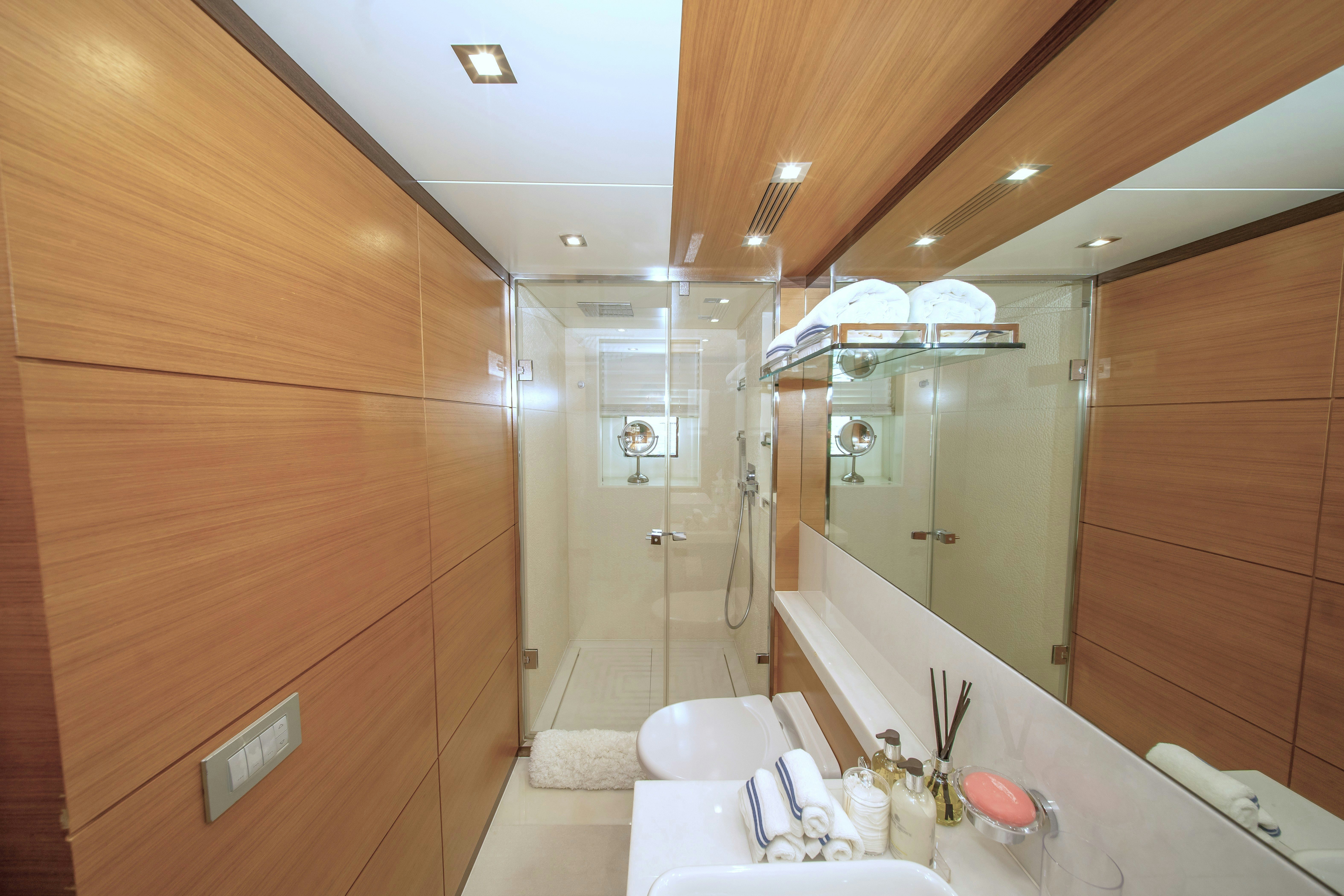 a bathroom with a large mirror aboard REHAB Yacht for Sale