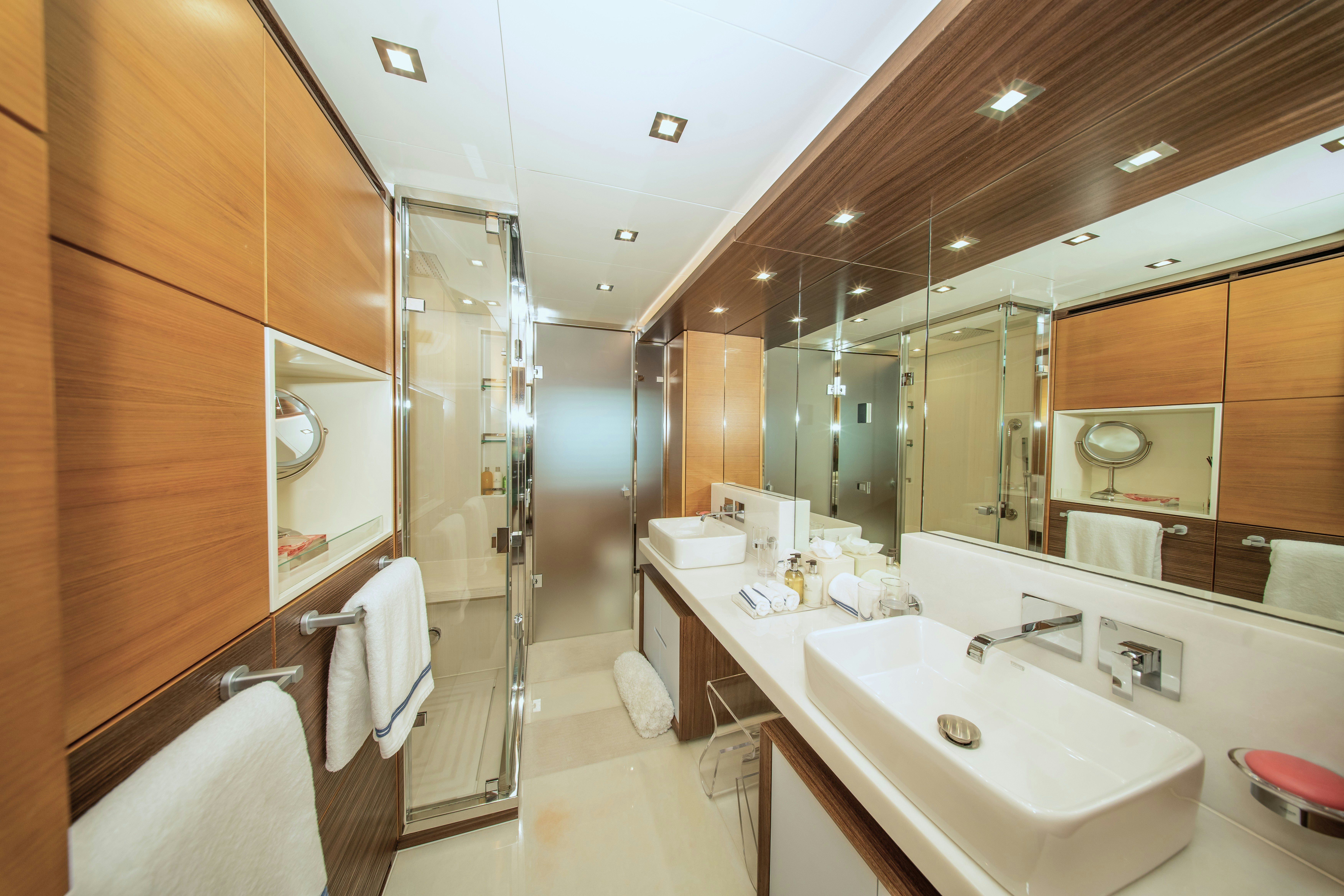 a bathroom with a large mirror aboard REHAB Yacht for Sale