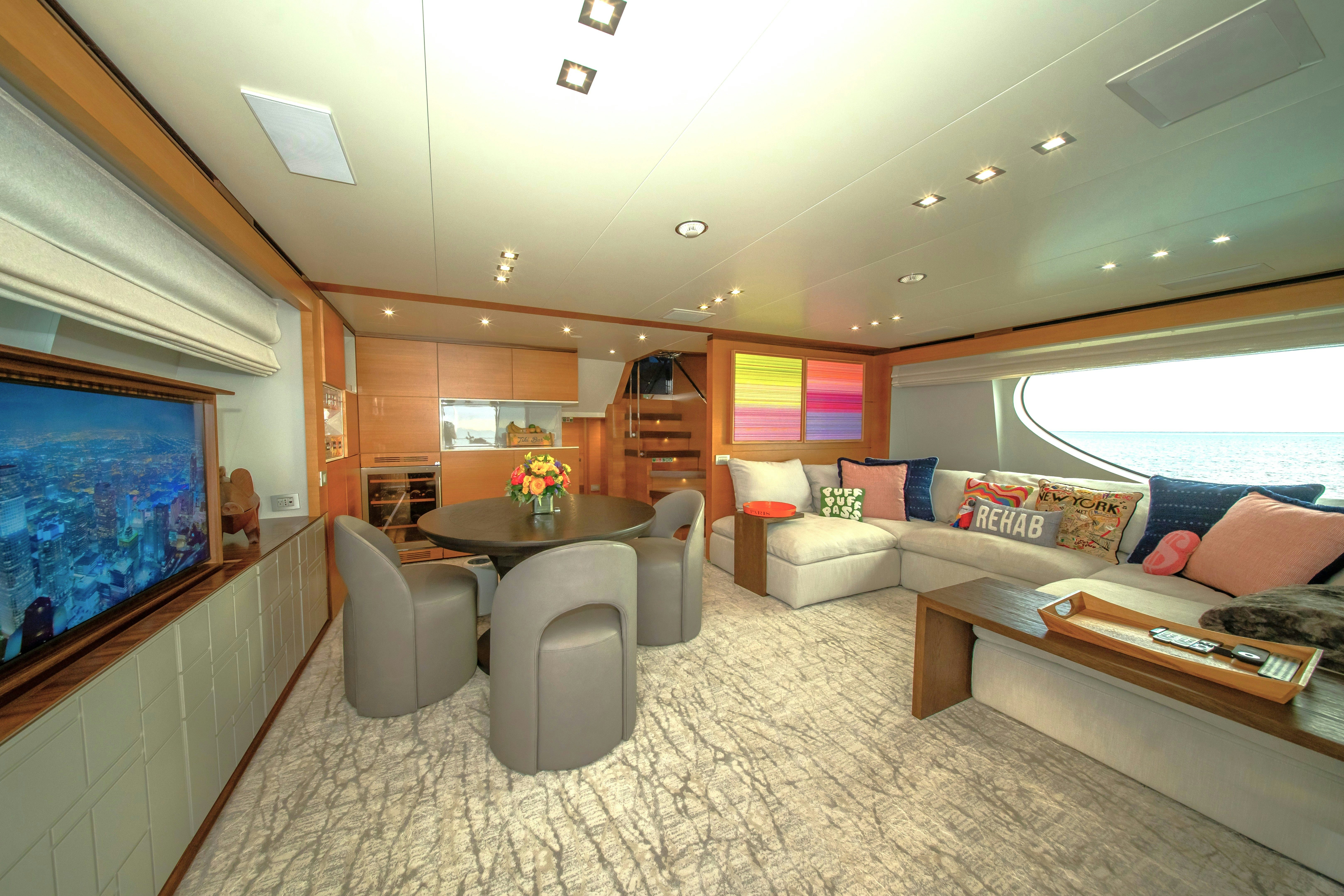 a living room with a large screen aboard REHAB Yacht for Sale