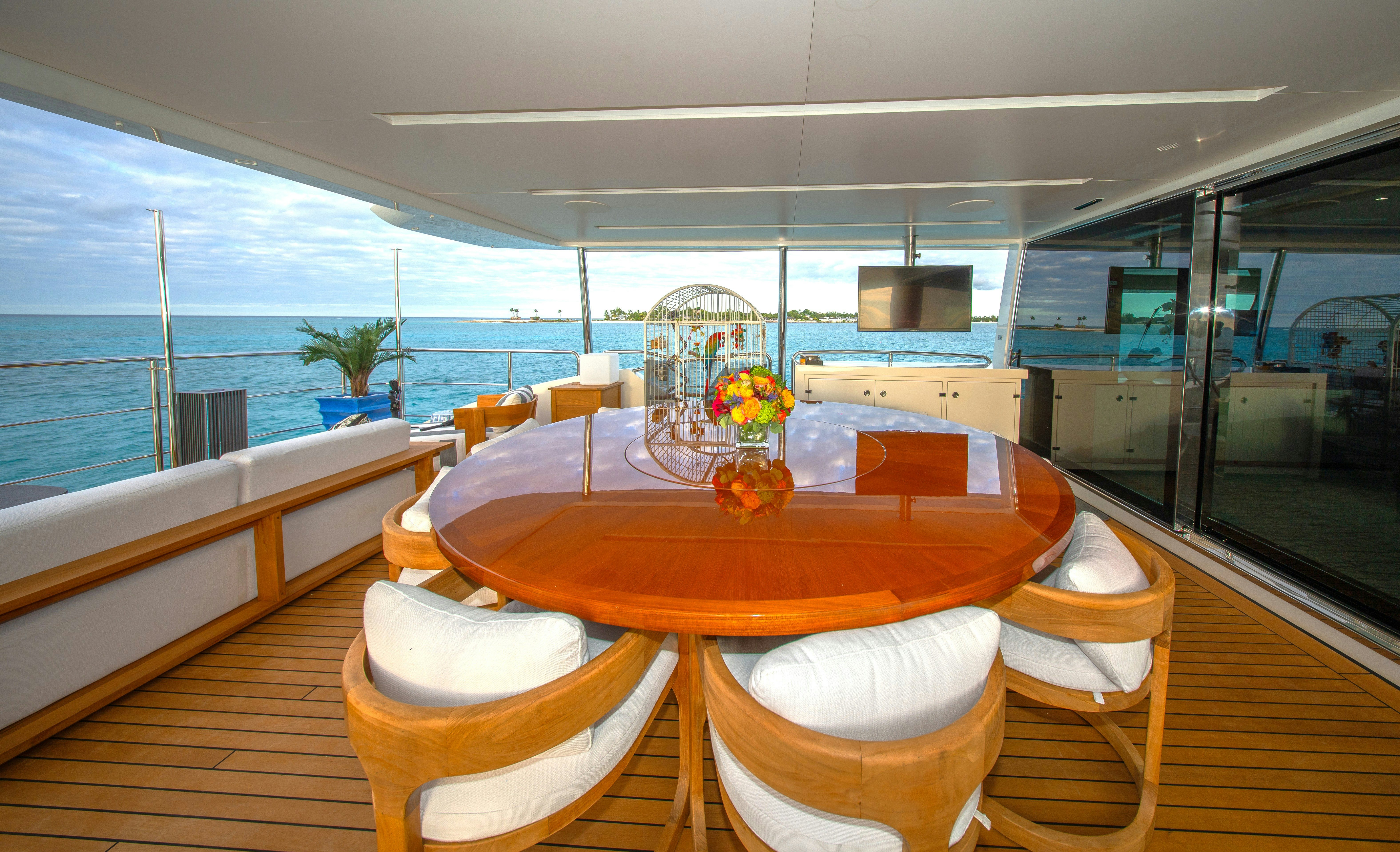 a dining table in a room aboard REHAB Yacht for Sale