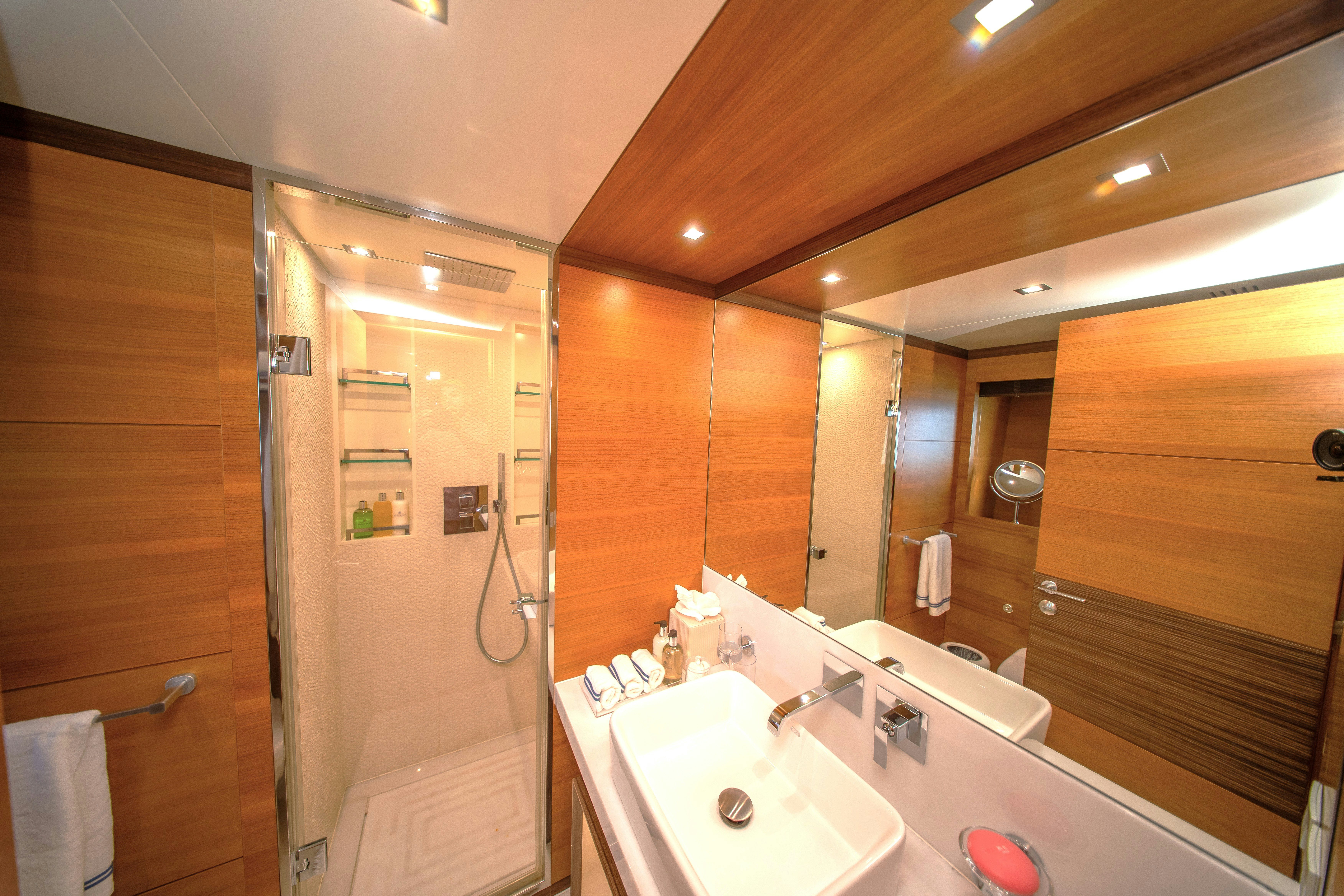 a bathroom with a large mirror aboard REHAB Yacht for Sale