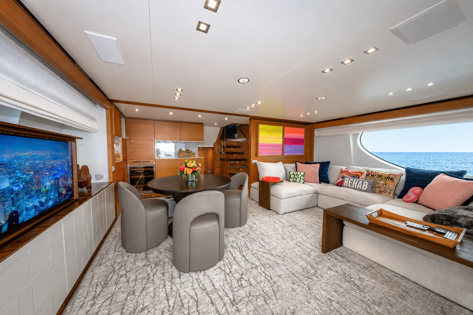 a living room with a large screen aboard REHAB Yacht for Sale