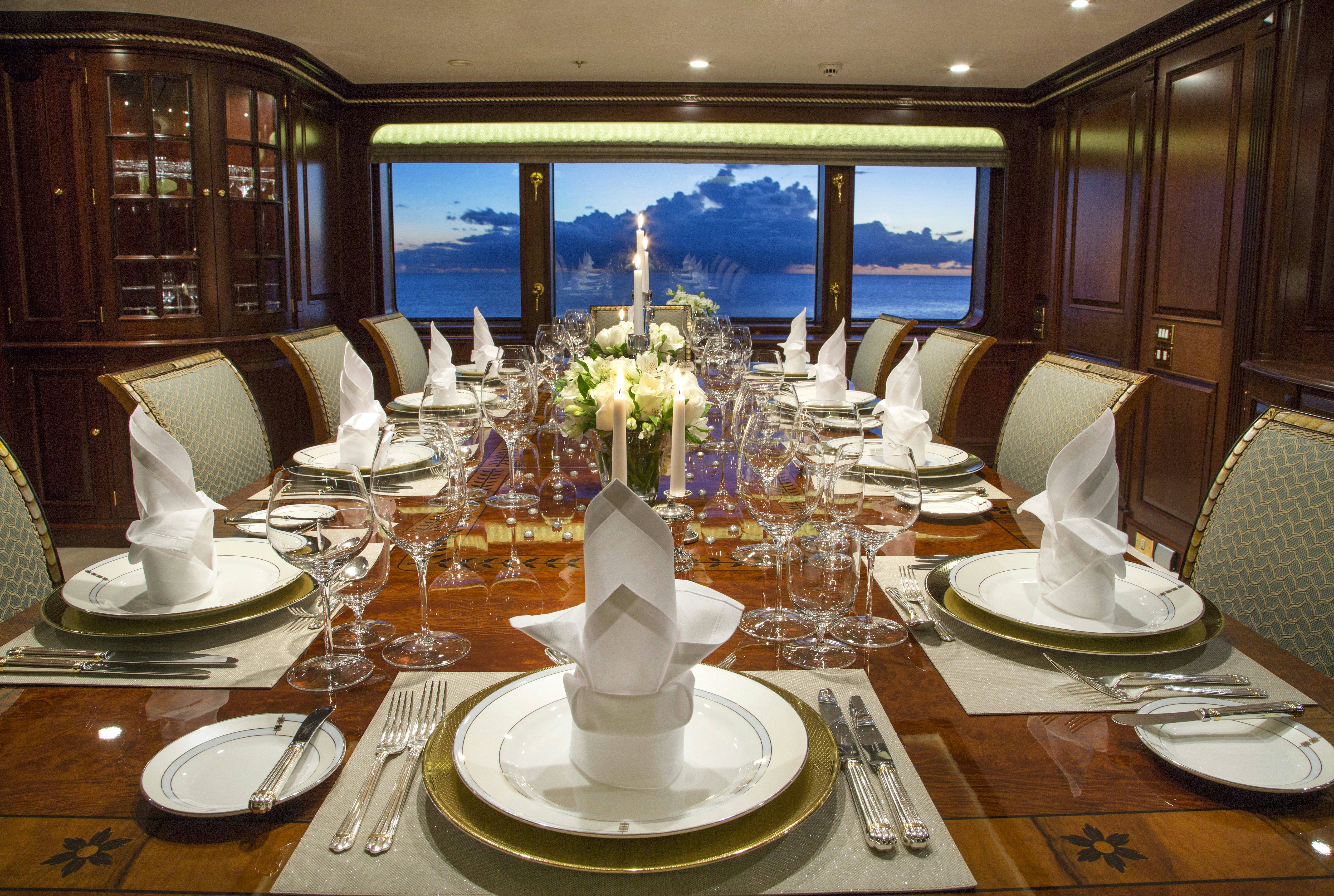 a table with plates and glasses aboard TELEOST Yacht for Charter