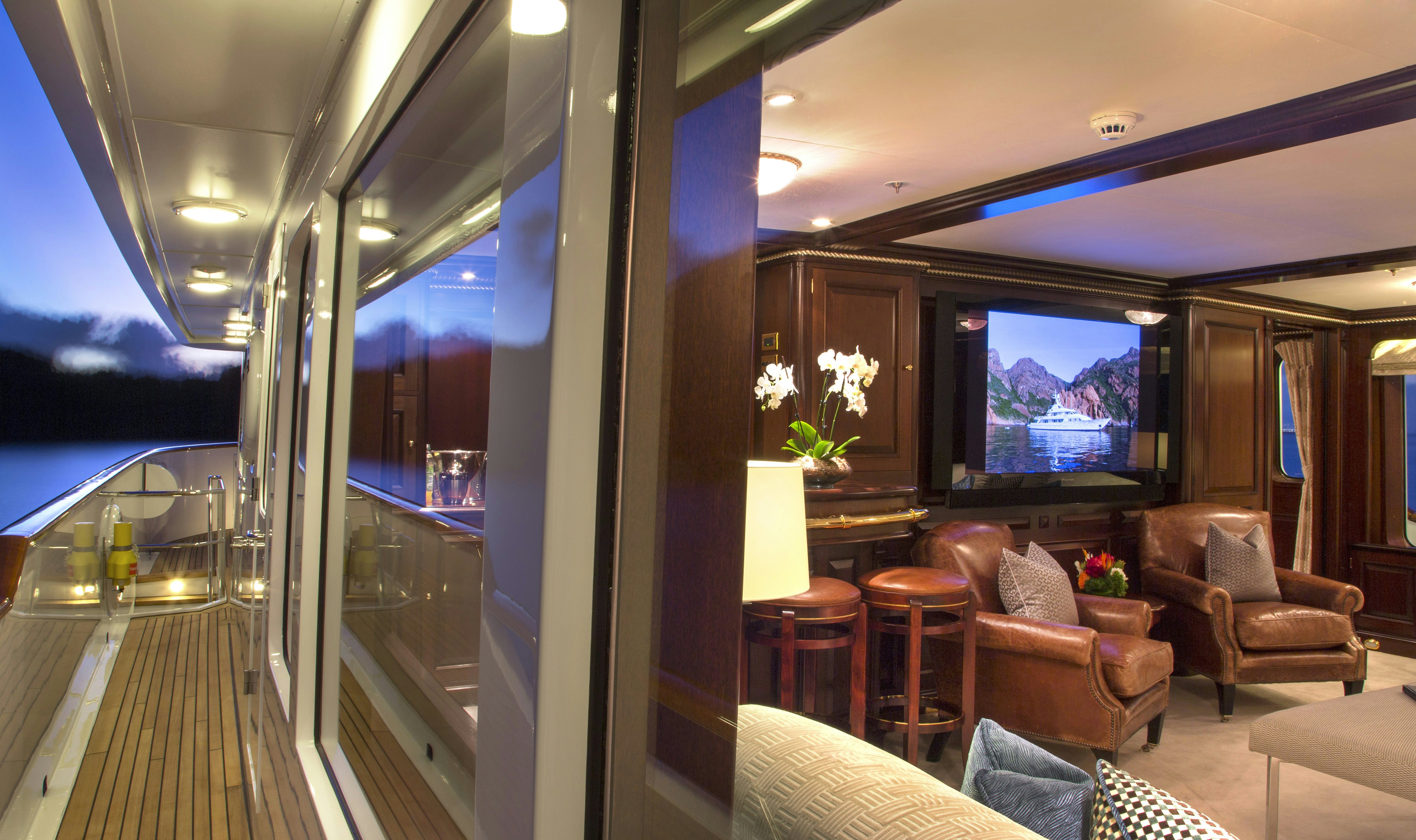 a living room with a large screen aboard TELEOST Yacht for Charter