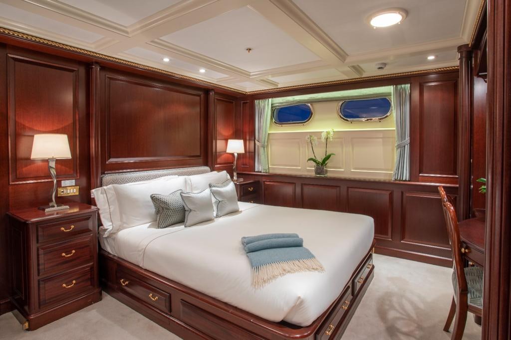 a large bedroom with a large bed aboard TELEOST Yacht for Charter