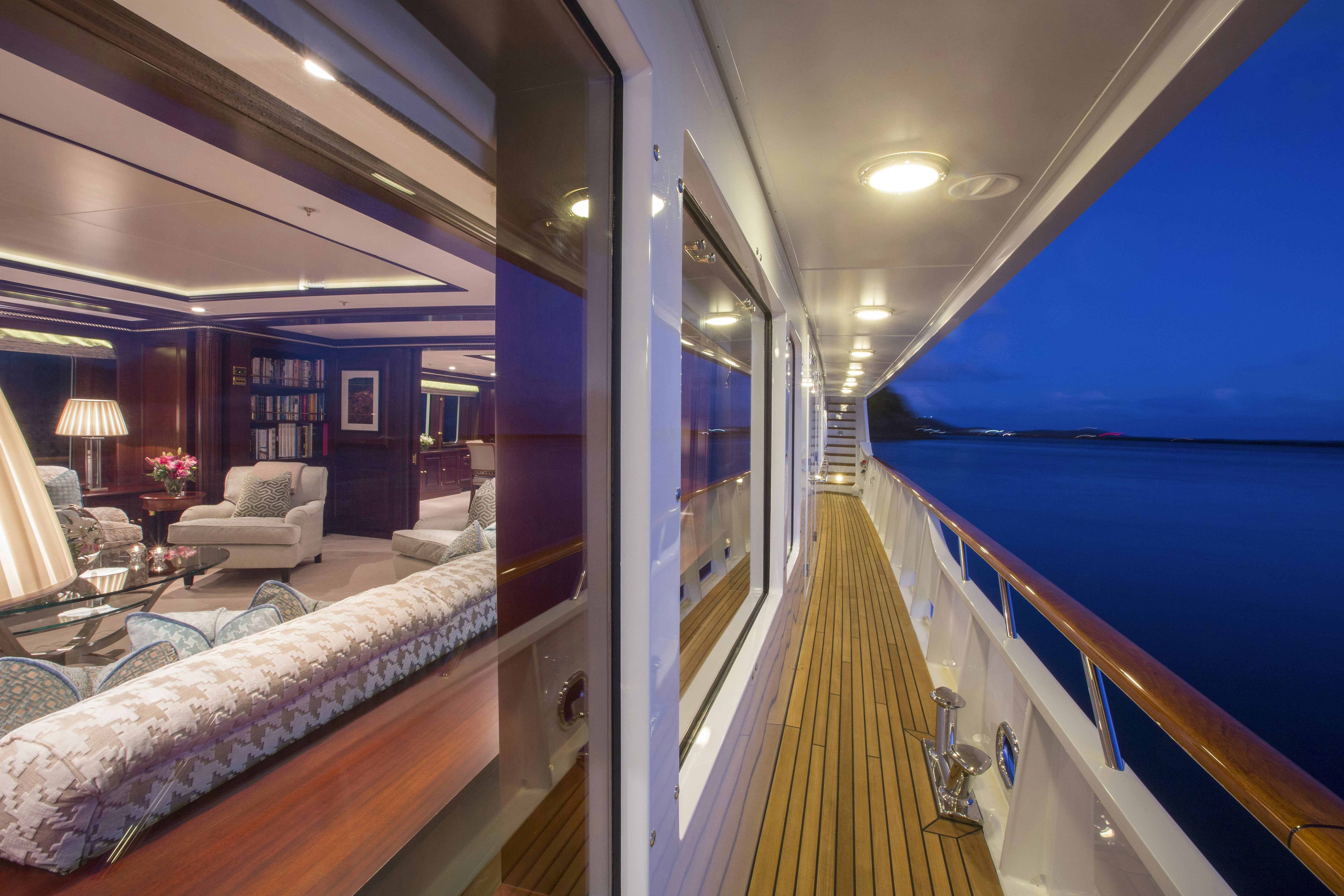 a living room with a balcony aboard TELEOST Yacht for Charter