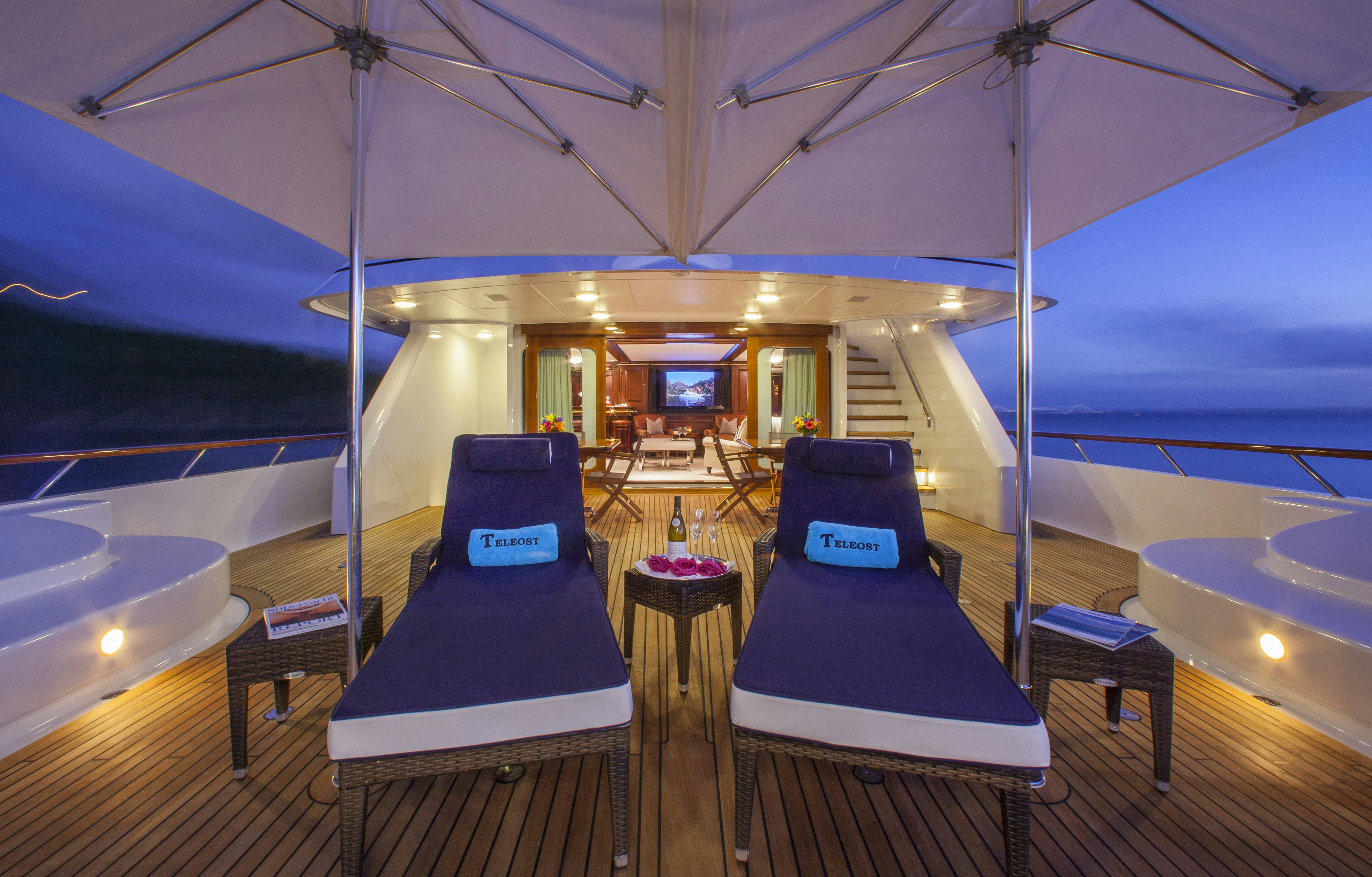 a tent with a couch and a table in it aboard TELEOST Yacht for Charter