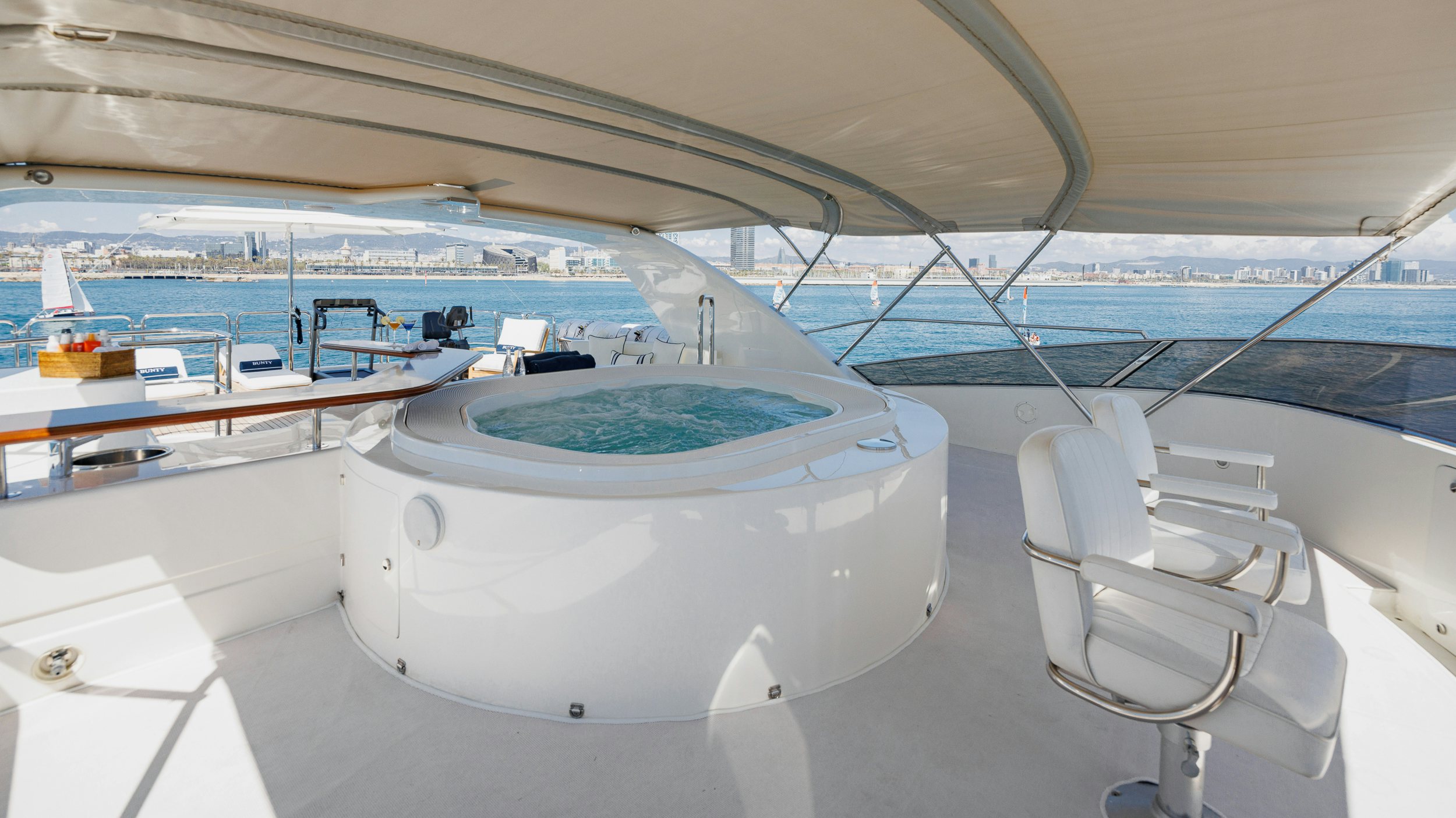 a large white boat in a large room with chairs and a table aboard BUNTY Yacht for Sale