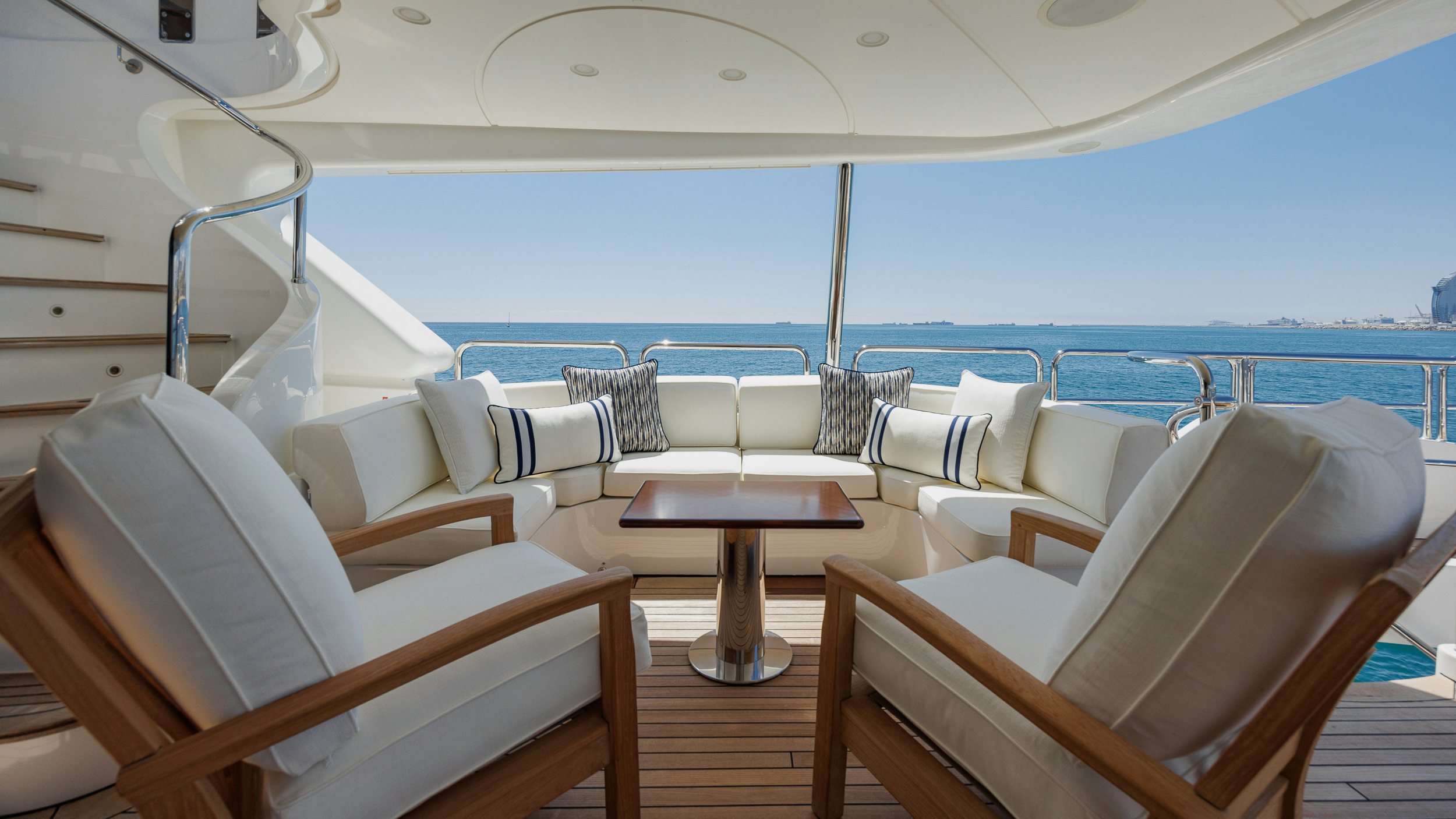 a room with a table chairs and a view of the ocean aboard BUNTY Yacht for Sale