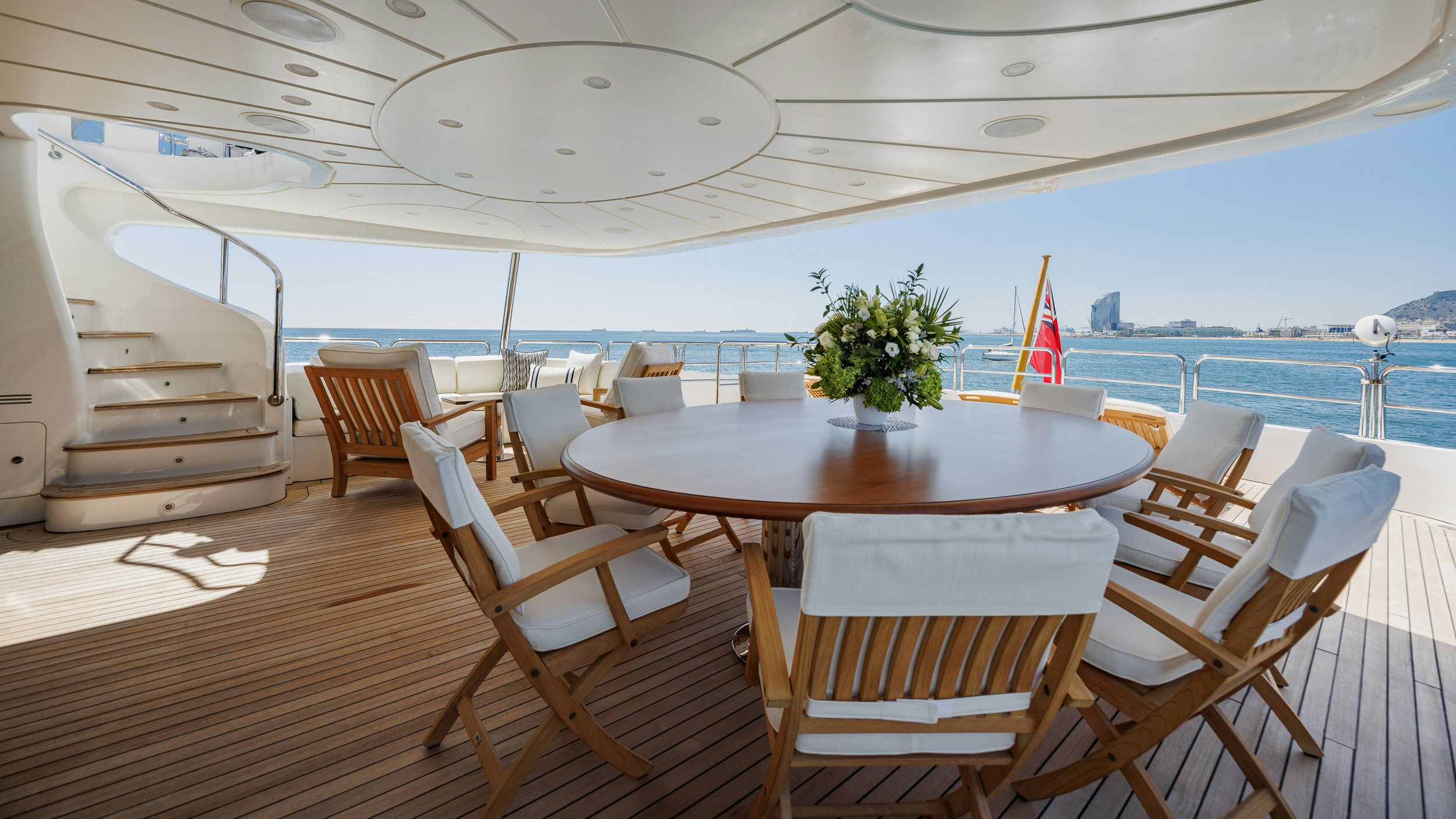 a table and chairs on a deck aboard BUNTY Yacht for Sale