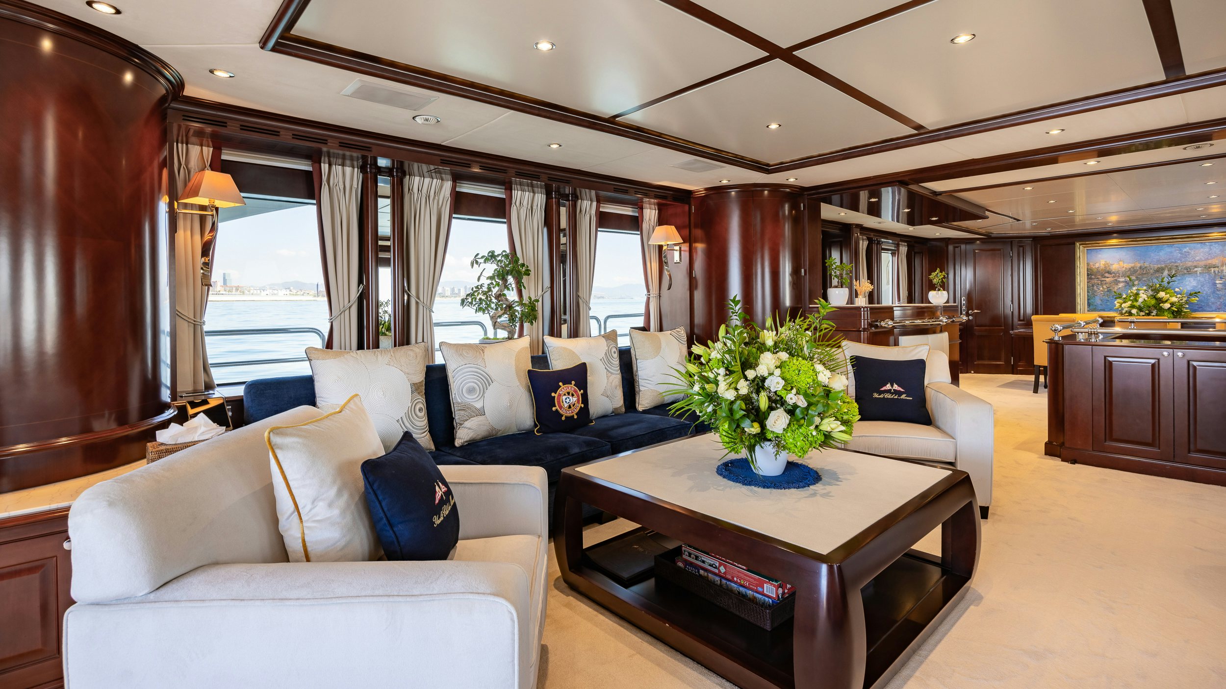 a living room with a table and couches aboard BUNTY Yacht for Sale