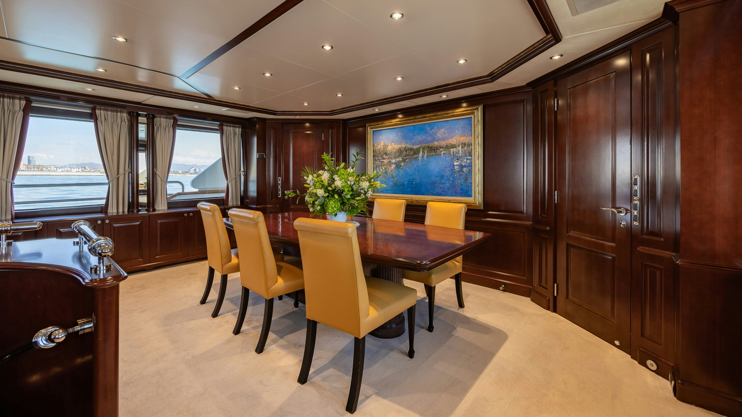 a room with a table and chairs aboard BUNTY Yacht for Sale