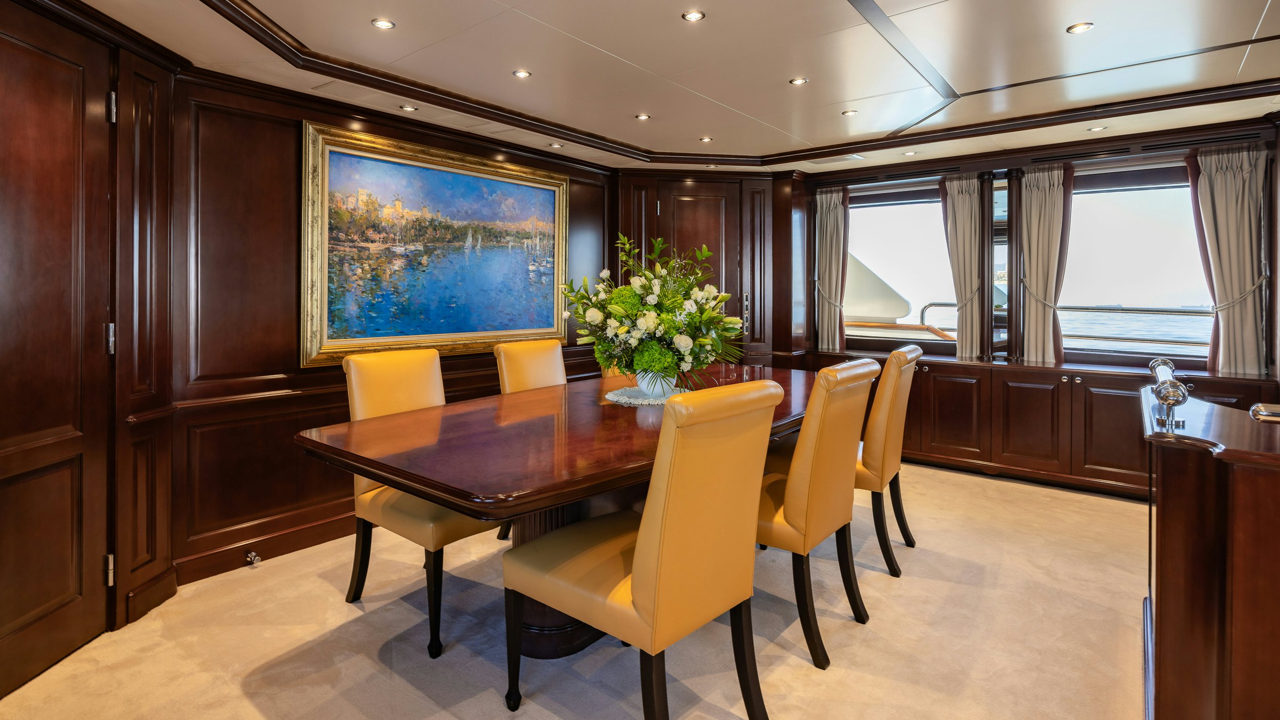 a large room with a table and chairs aboard BUNTY Yacht for Sale