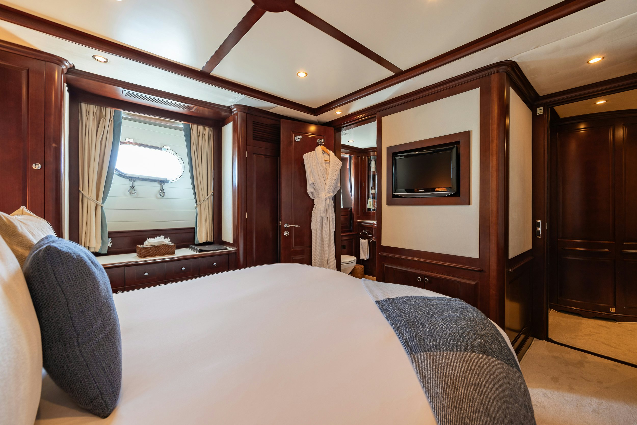 a bedroom with a bed and a television aboard BUNTY Yacht for Sale