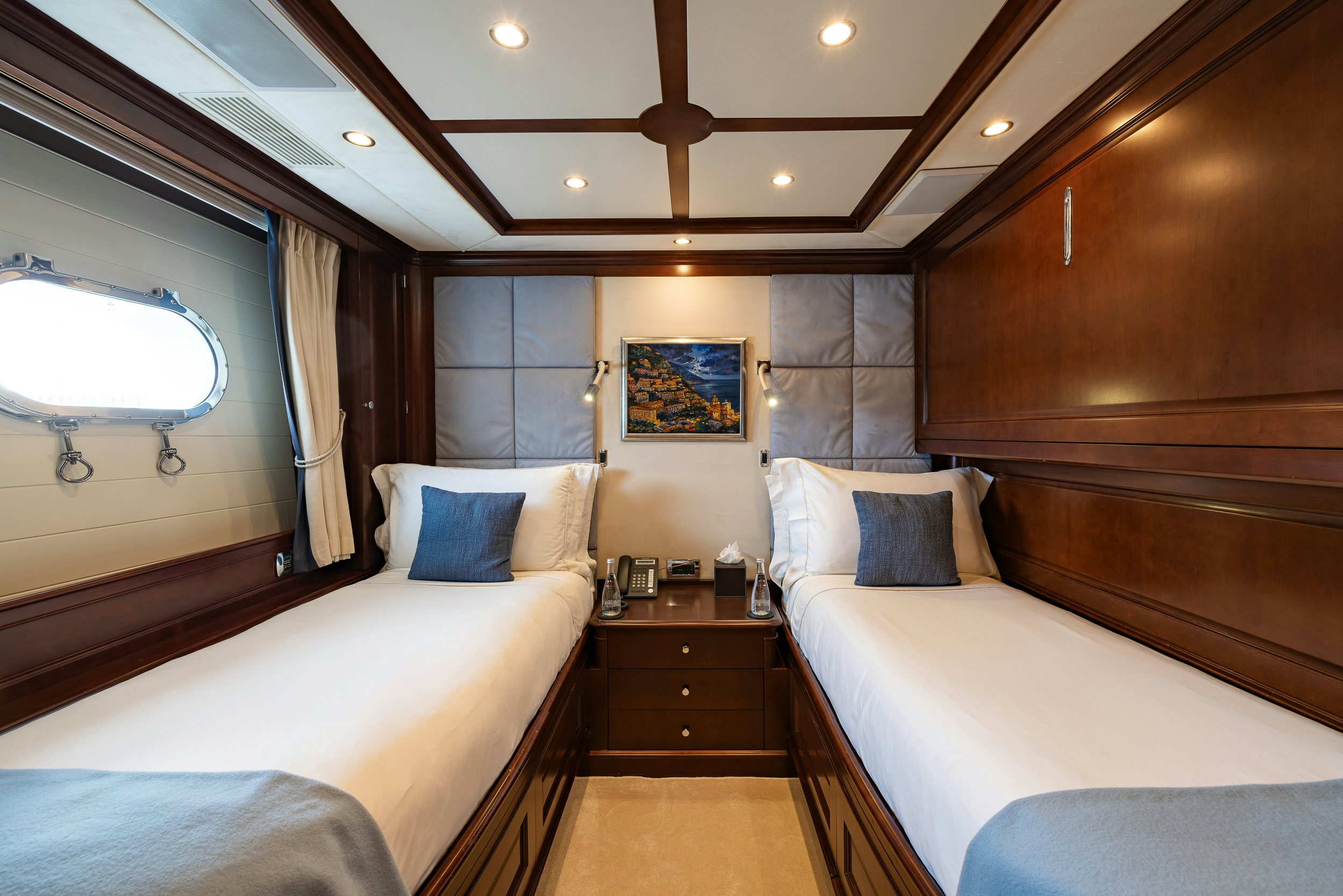 a room with a bed and a window aboard BUNTY Yacht for Sale