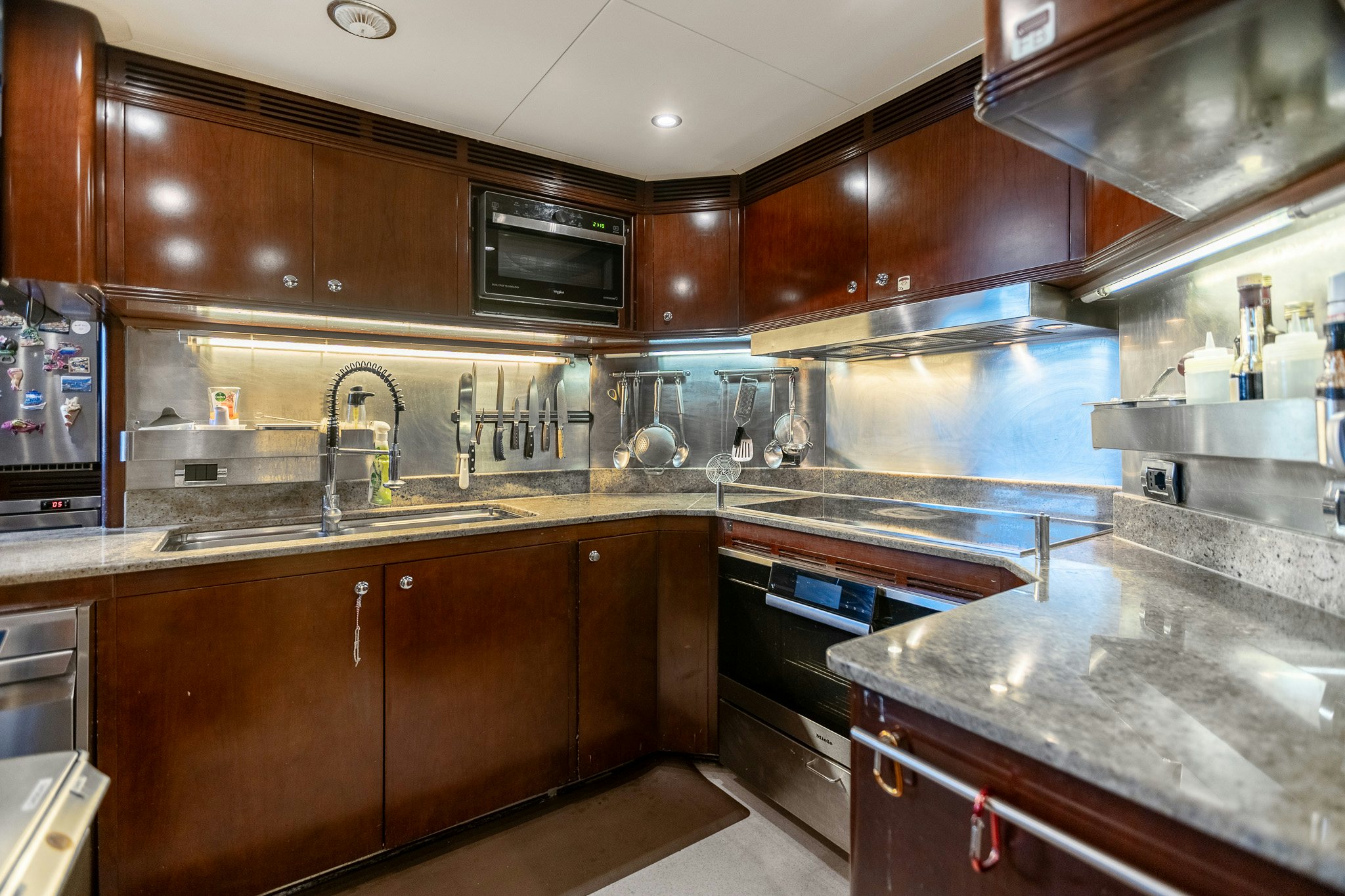 a kitchen with wooden cabinets aboard BUNTY Yacht for Sale