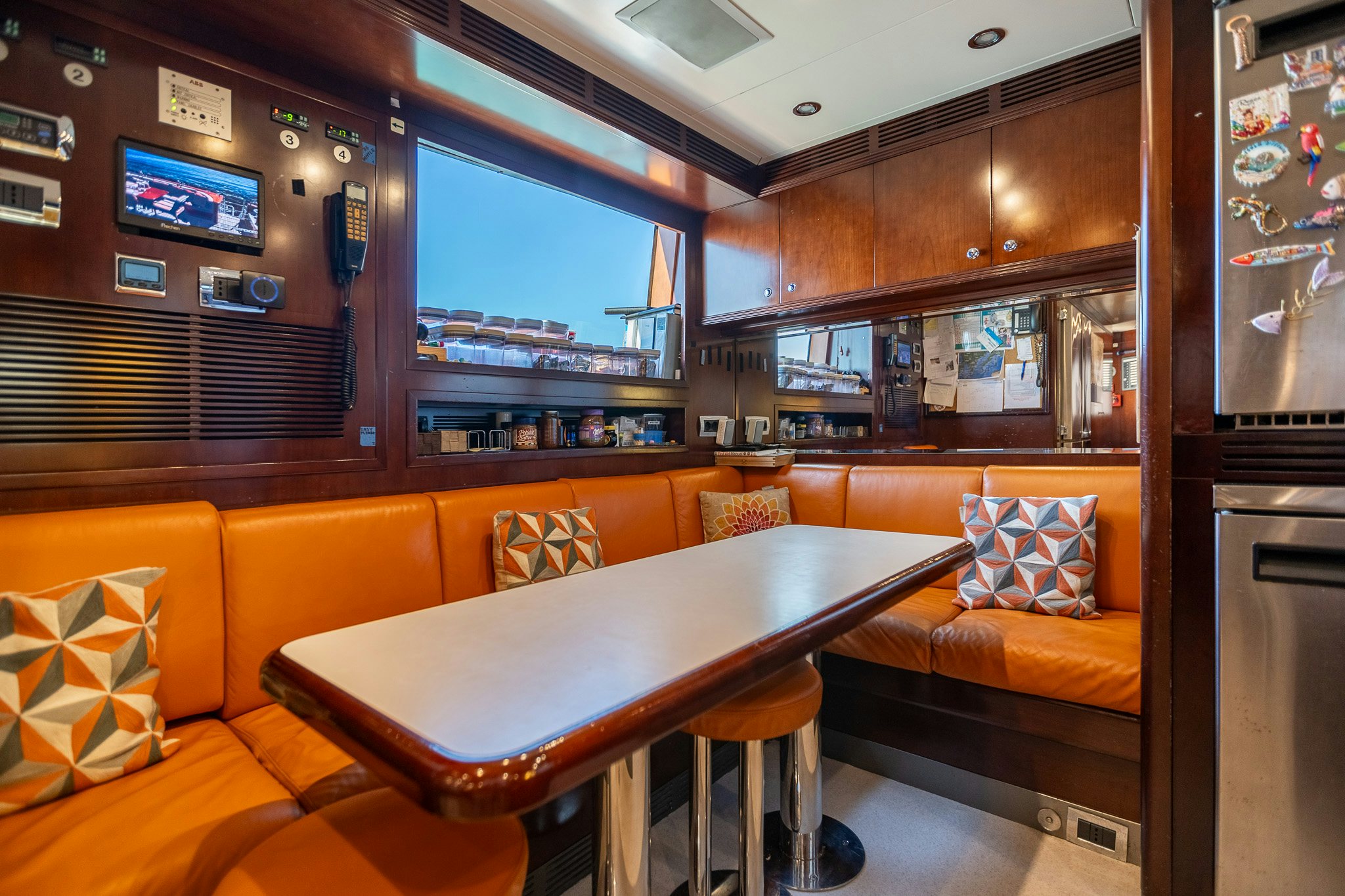 a room with a table and couch aboard BUNTY Yacht for Sale