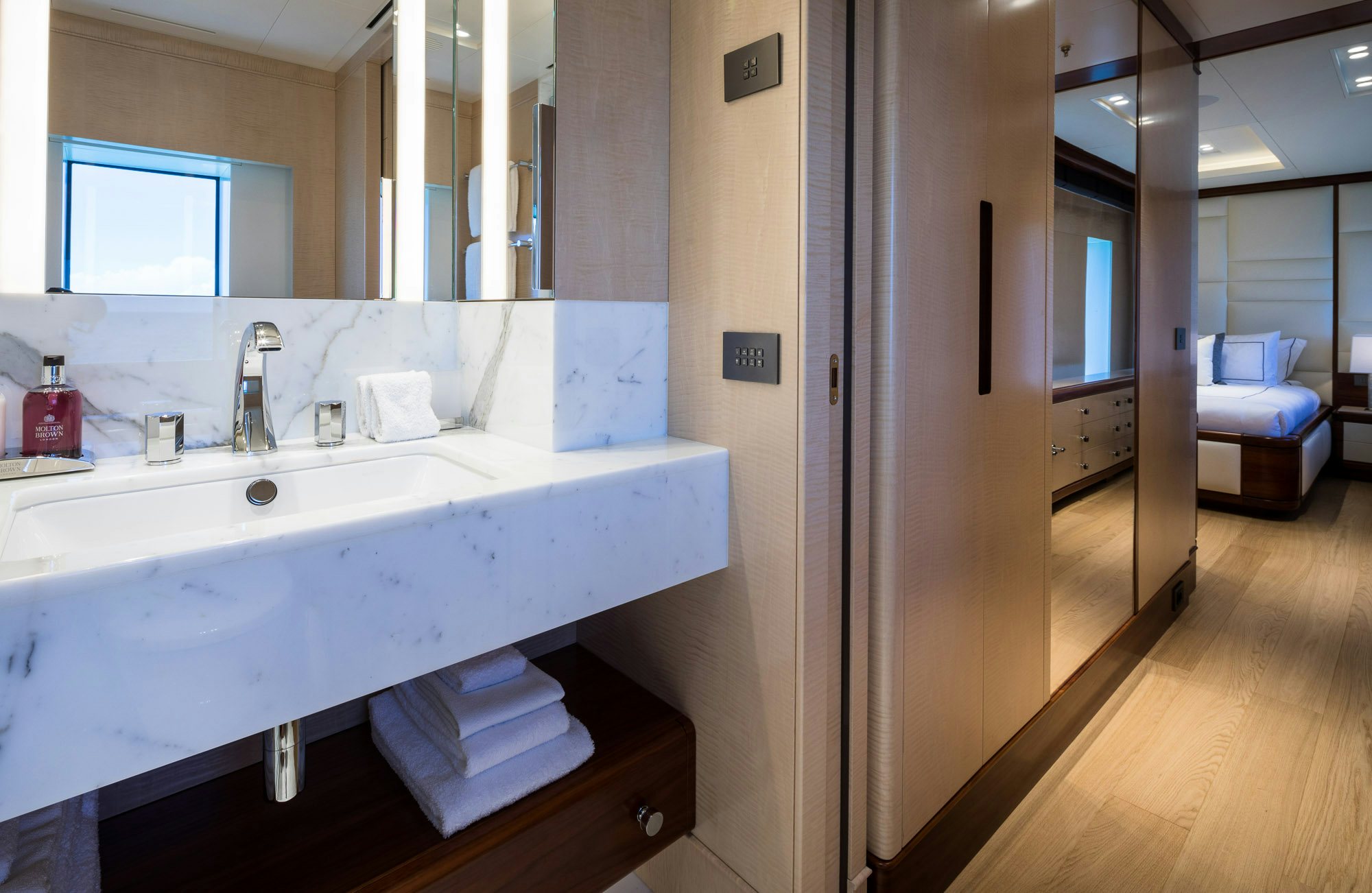 a bathroom with a sink and a mirror aboard CALEX Yacht for Charter