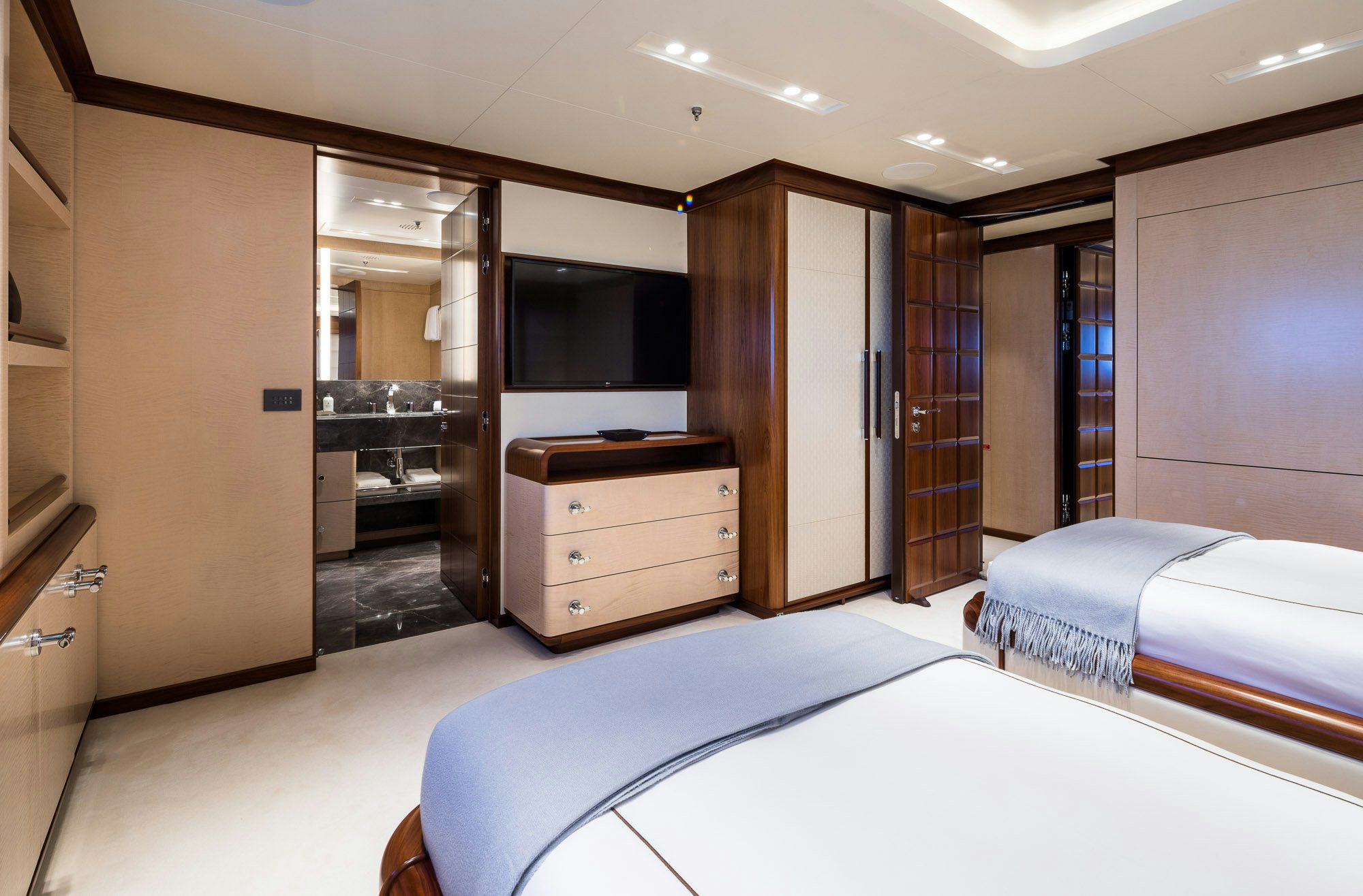 a hotel room with a bed and a tv aboard CALEX Yacht for Charter