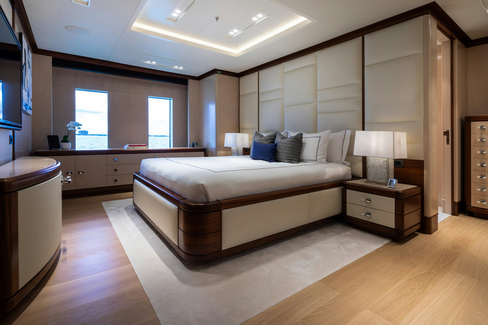a large bedroom with a bed aboard CALEX Yacht for Charter