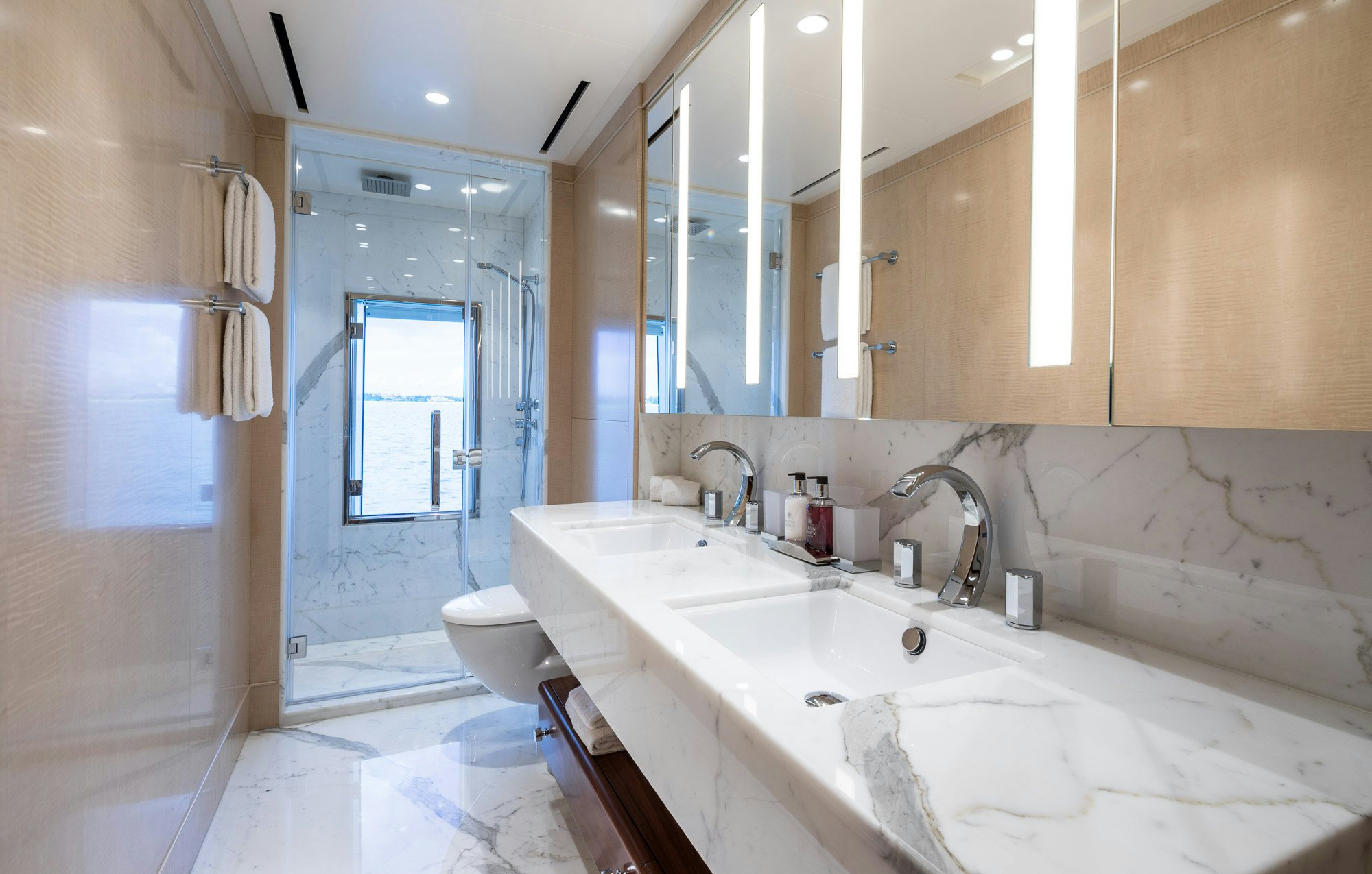 a bathroom with a tub sink and toilet aboard CALEX Yacht for Charter