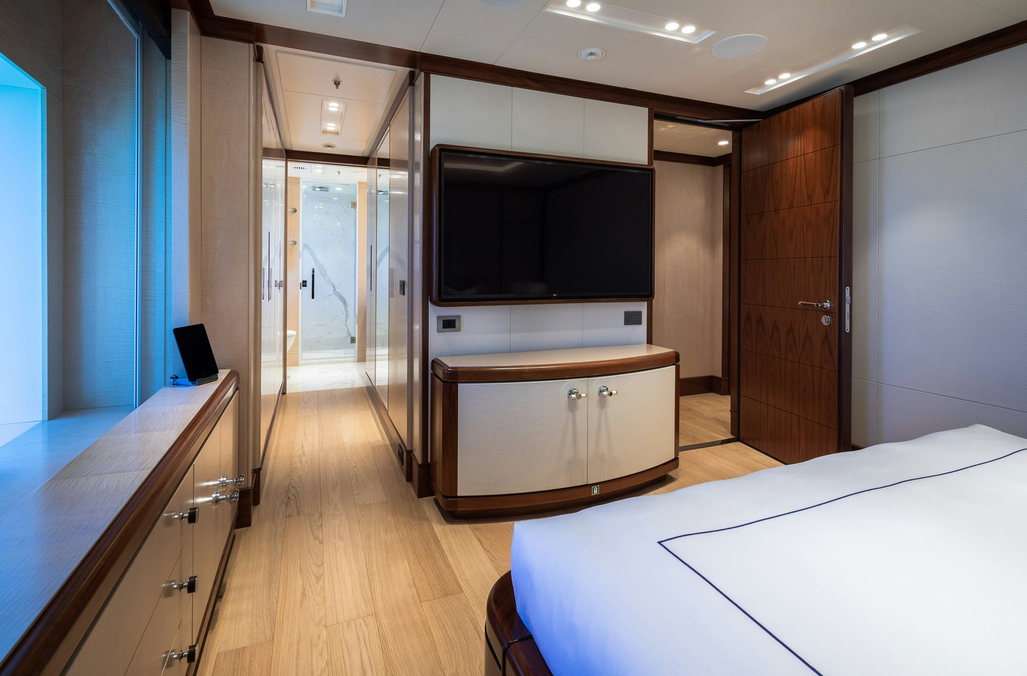 a room with a bed and a tv aboard CALEX Yacht for Charter