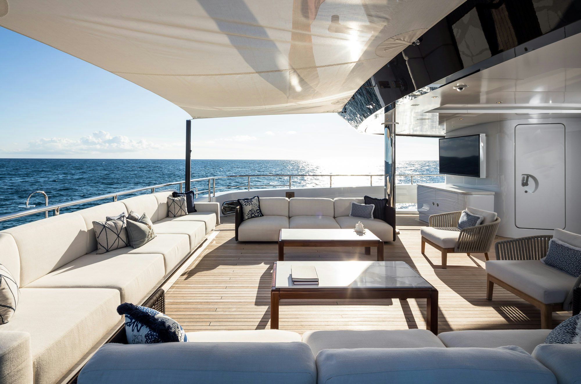 a living room with a large body of water aboard CALEX Yacht for Charter
