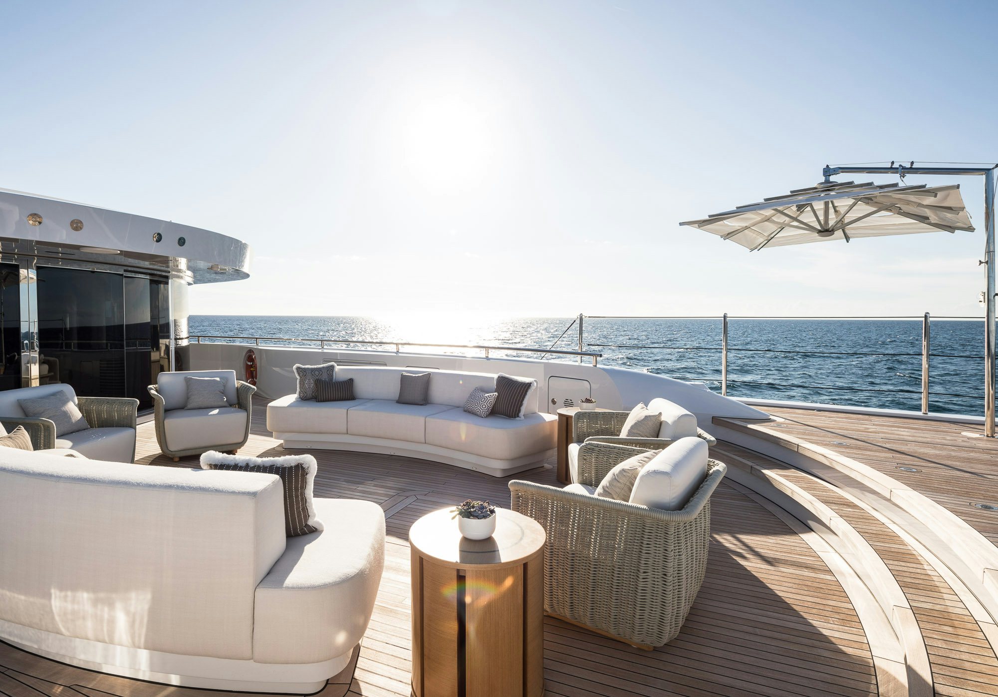 a large living room with a large body of water aboard CALEX Yacht for Charter