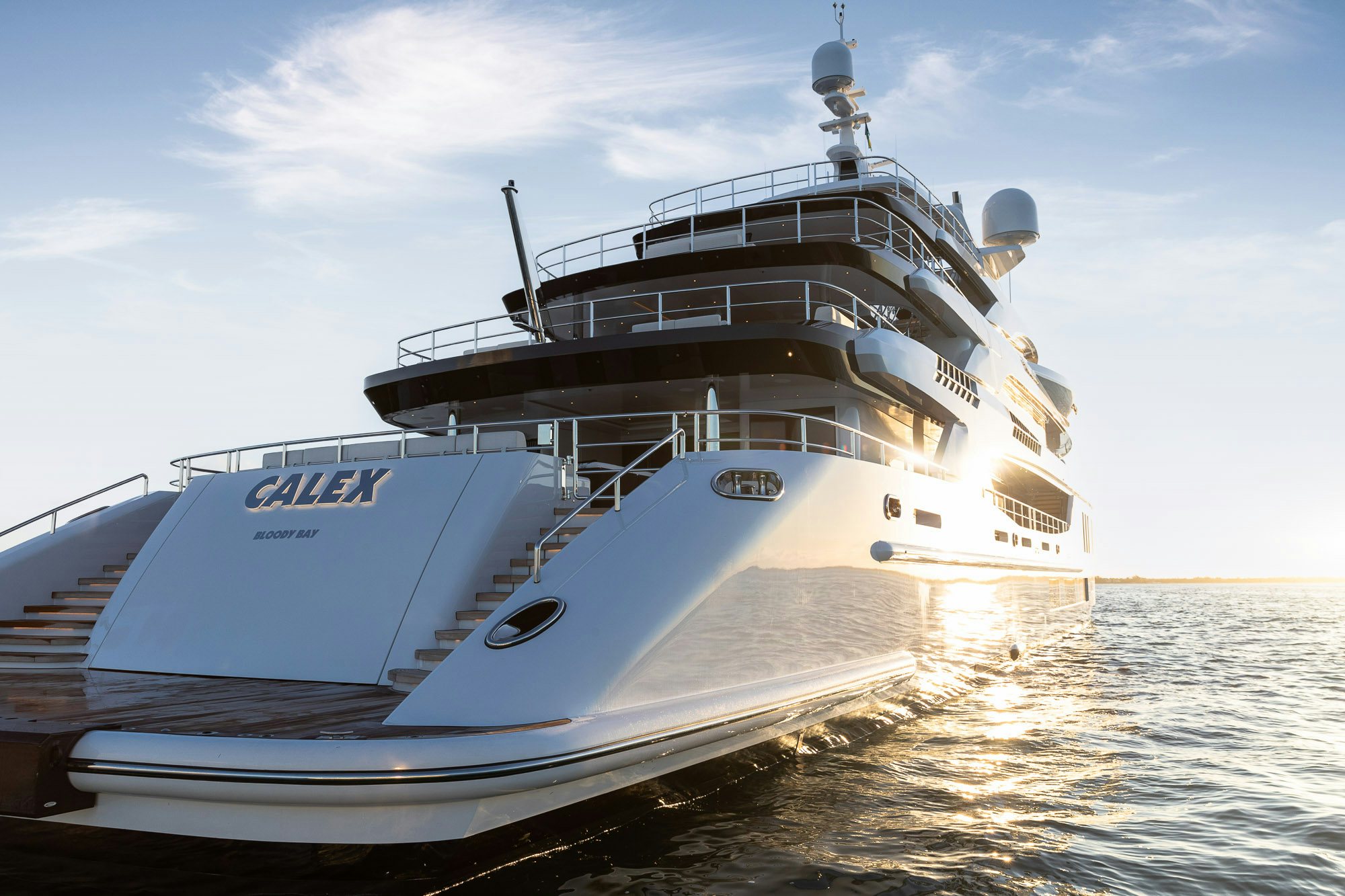 a large white boat on the water aboard CALEX Yacht for Charter