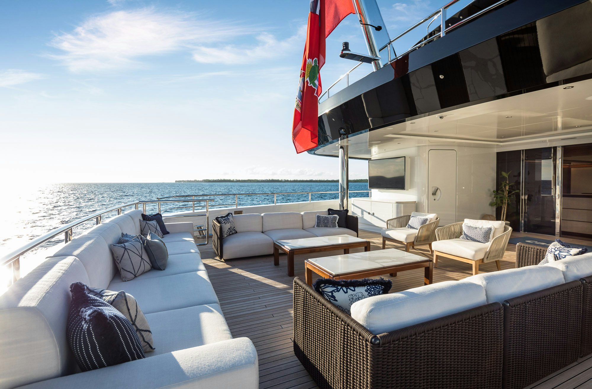 a large living room with a large body of water aboard CALEX Yacht for Charter
