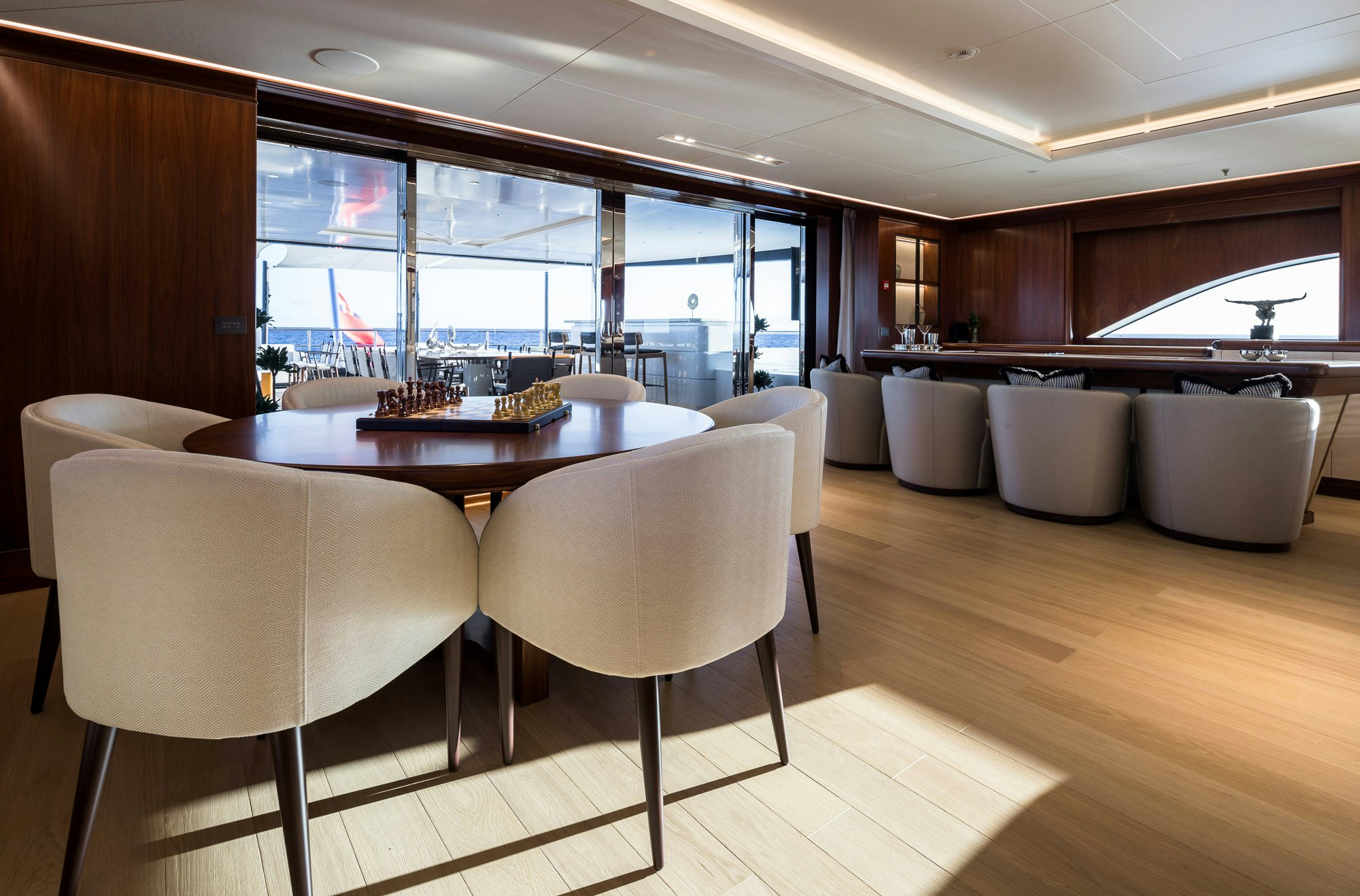 a room with a table and chairs aboard CALEX Yacht for Charter